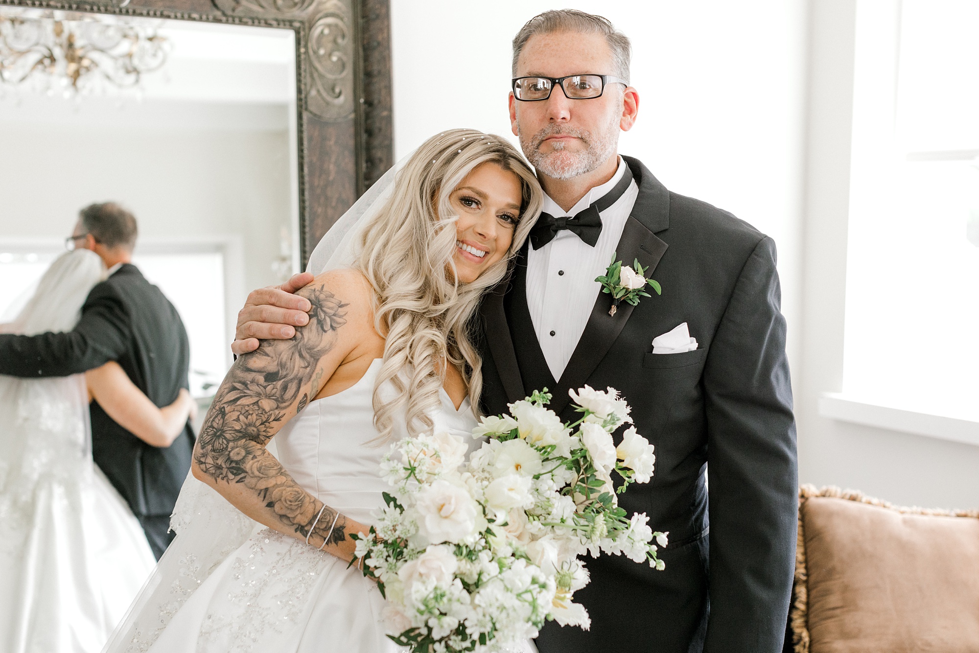 bride leans into dad's shoulder during first look