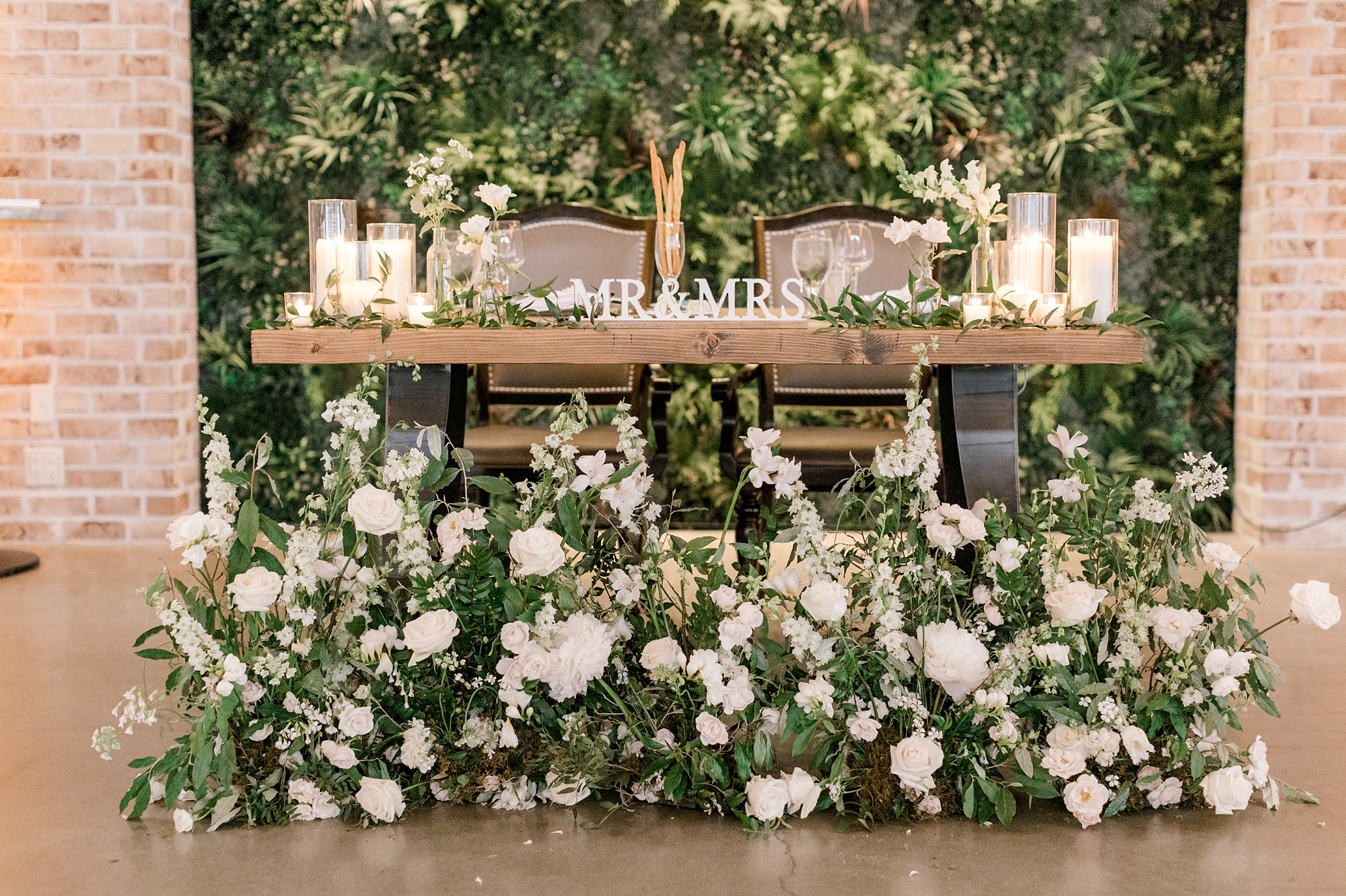 sweetheart table with white flowers all along bottom