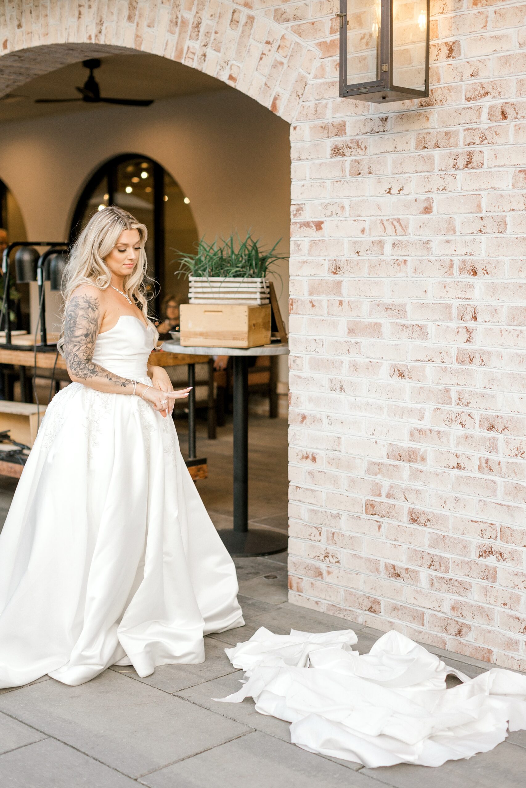 bride looks at scraps of wedding dress during reception