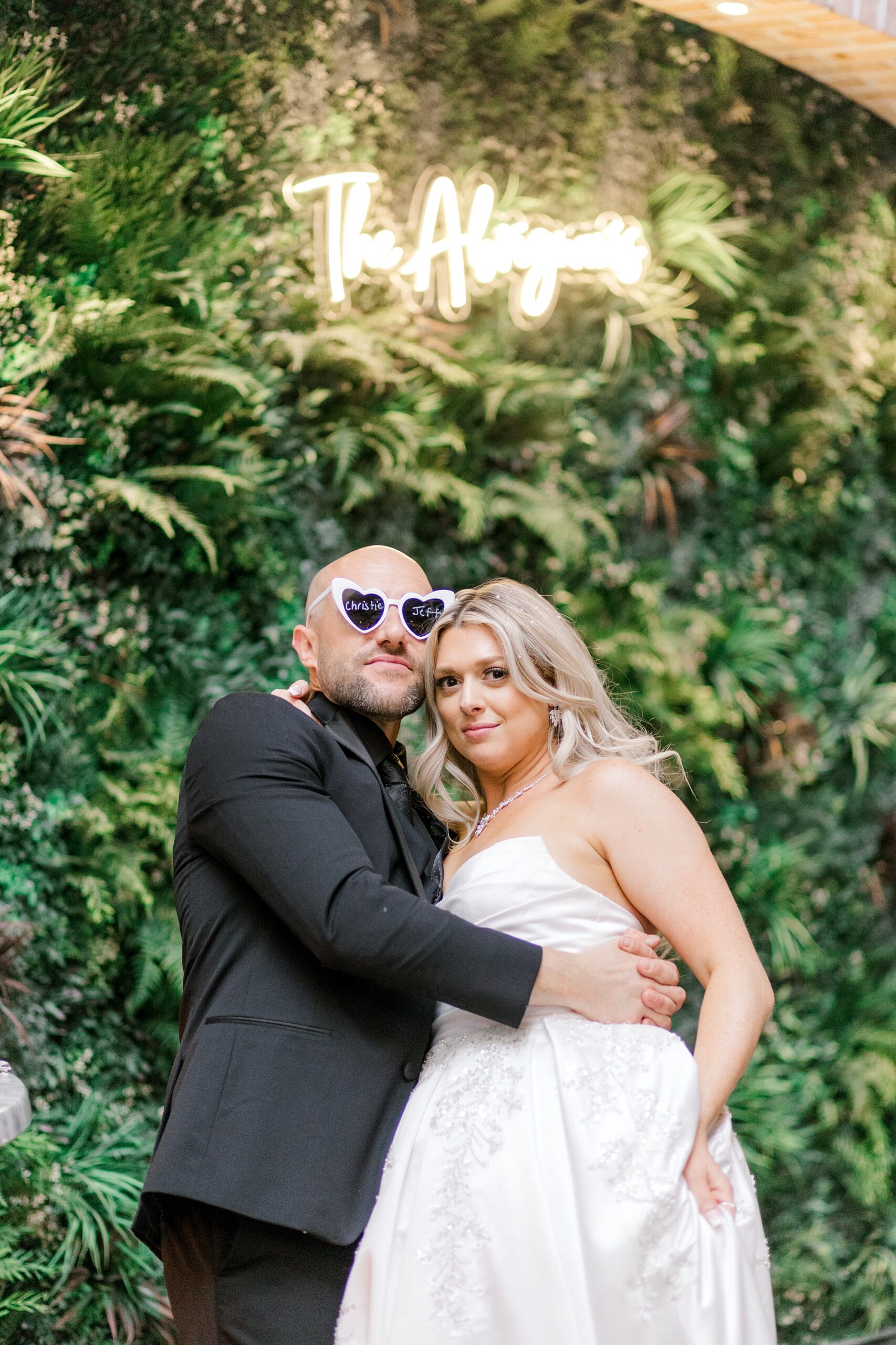 bride and groom hug wearing custom glasses during NJ wedding reception