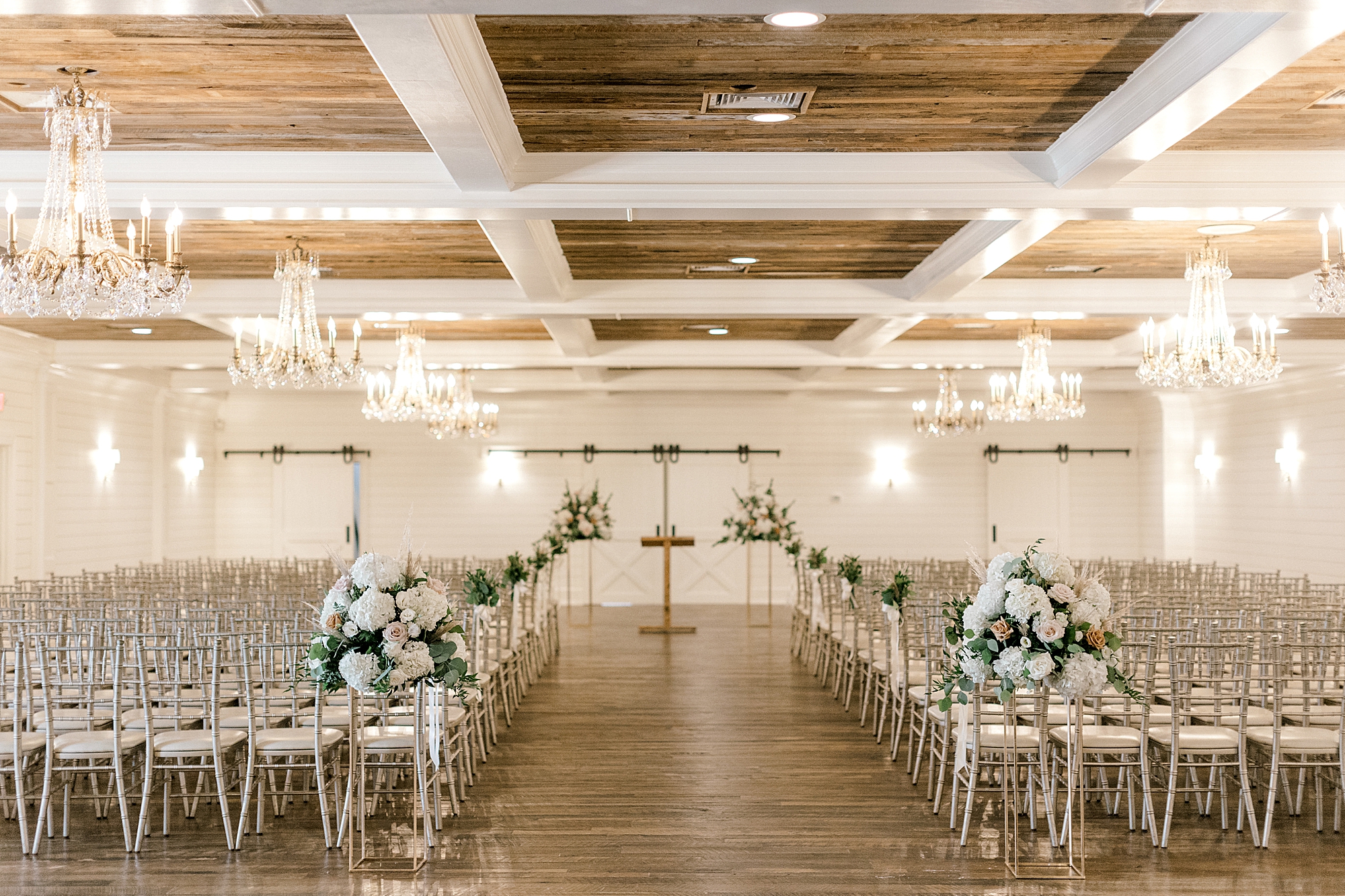 wedding ceremony setup in white room with wood accents at the Mansion at Mountain Lakes
