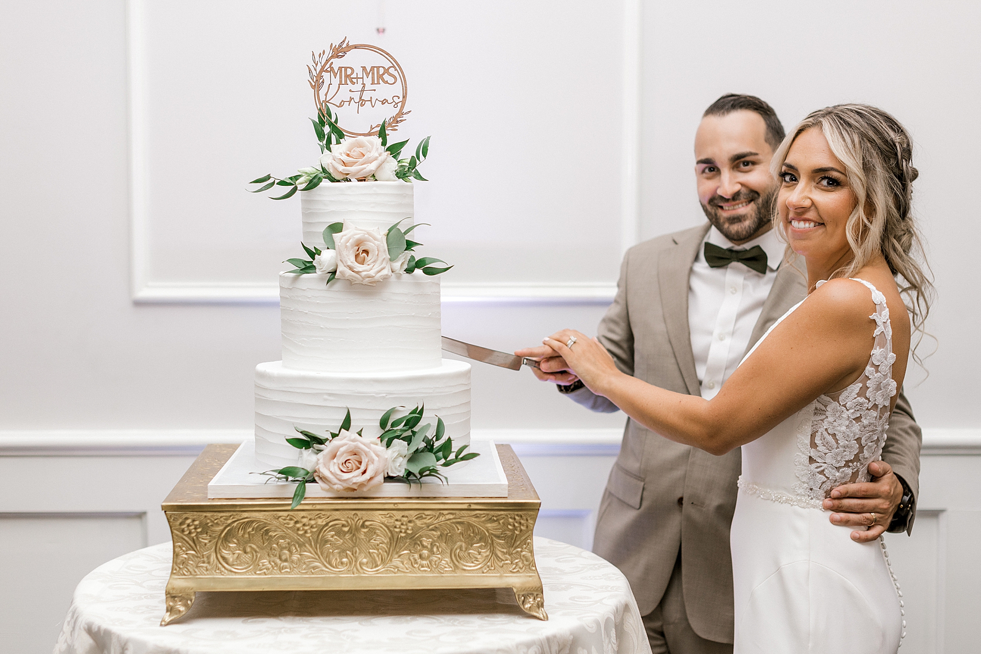 newlyweds cut tiered wedding cake during Mountain Lakes NJ wedding reception