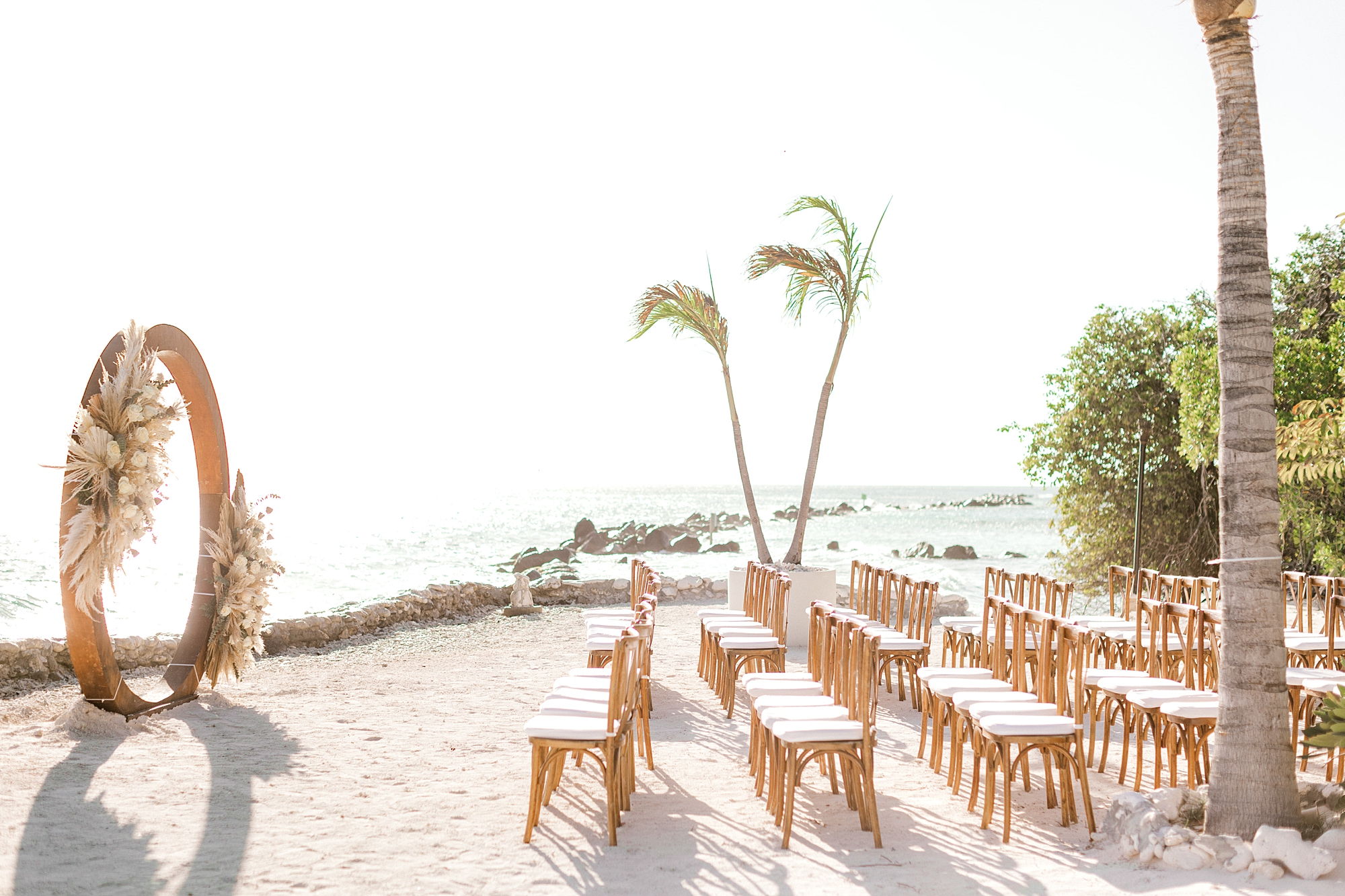 ceremony site on Flamingo Island with brown circular arbor and pew seating