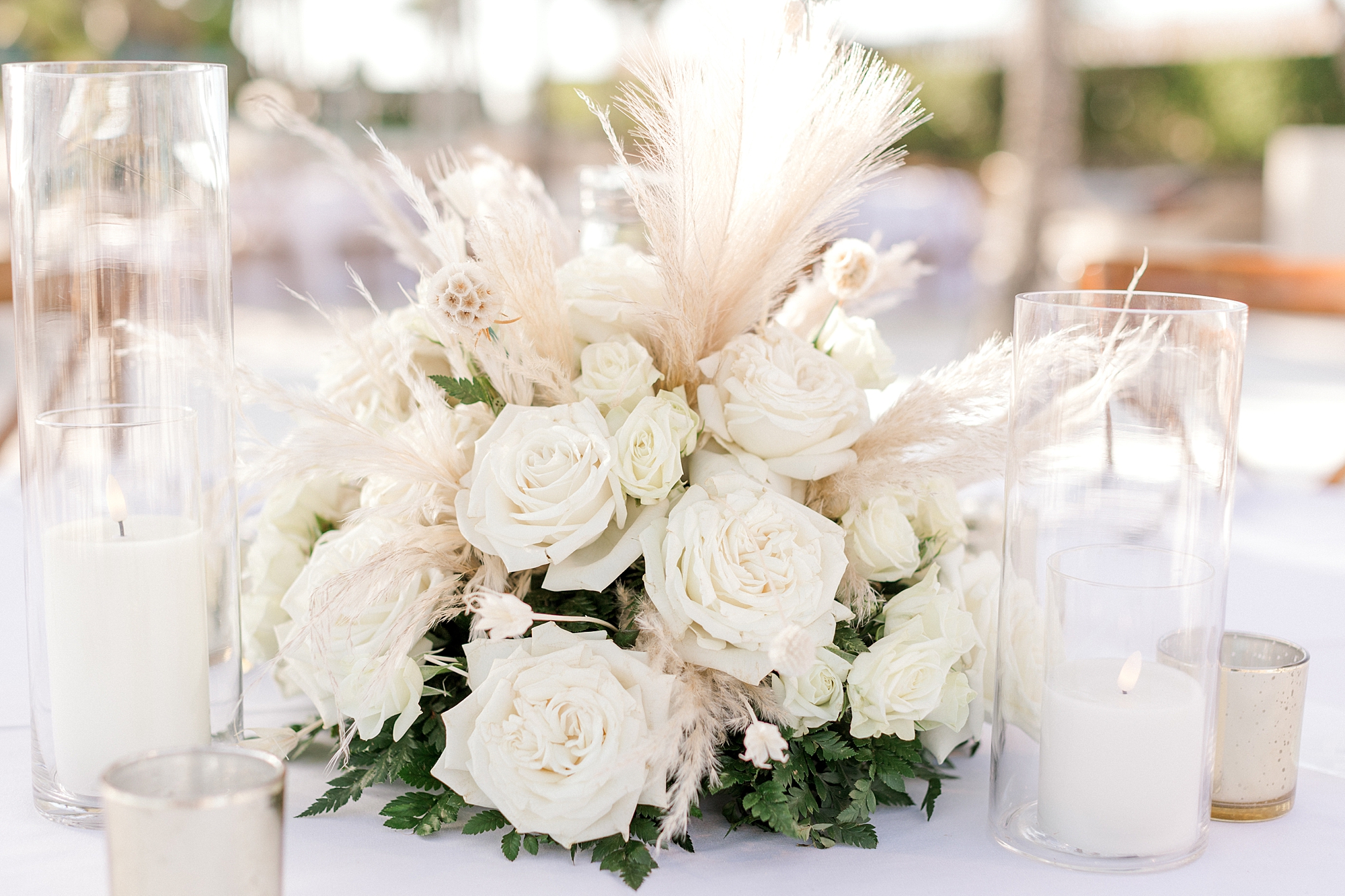 white roses with tan accents centerpieces for destination beach wedding