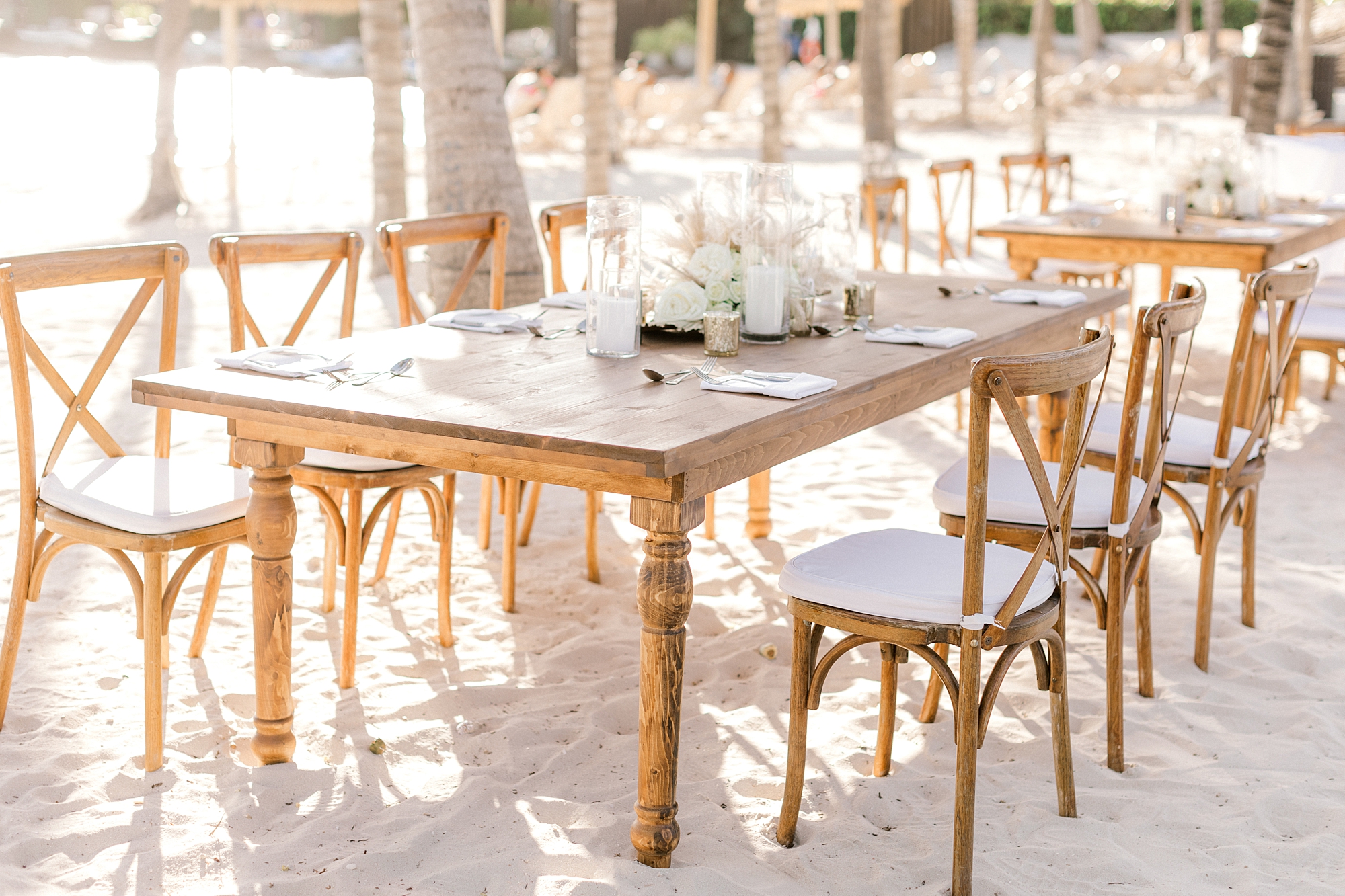 wedding reception seating at wooden table on beach on Flamingo Island