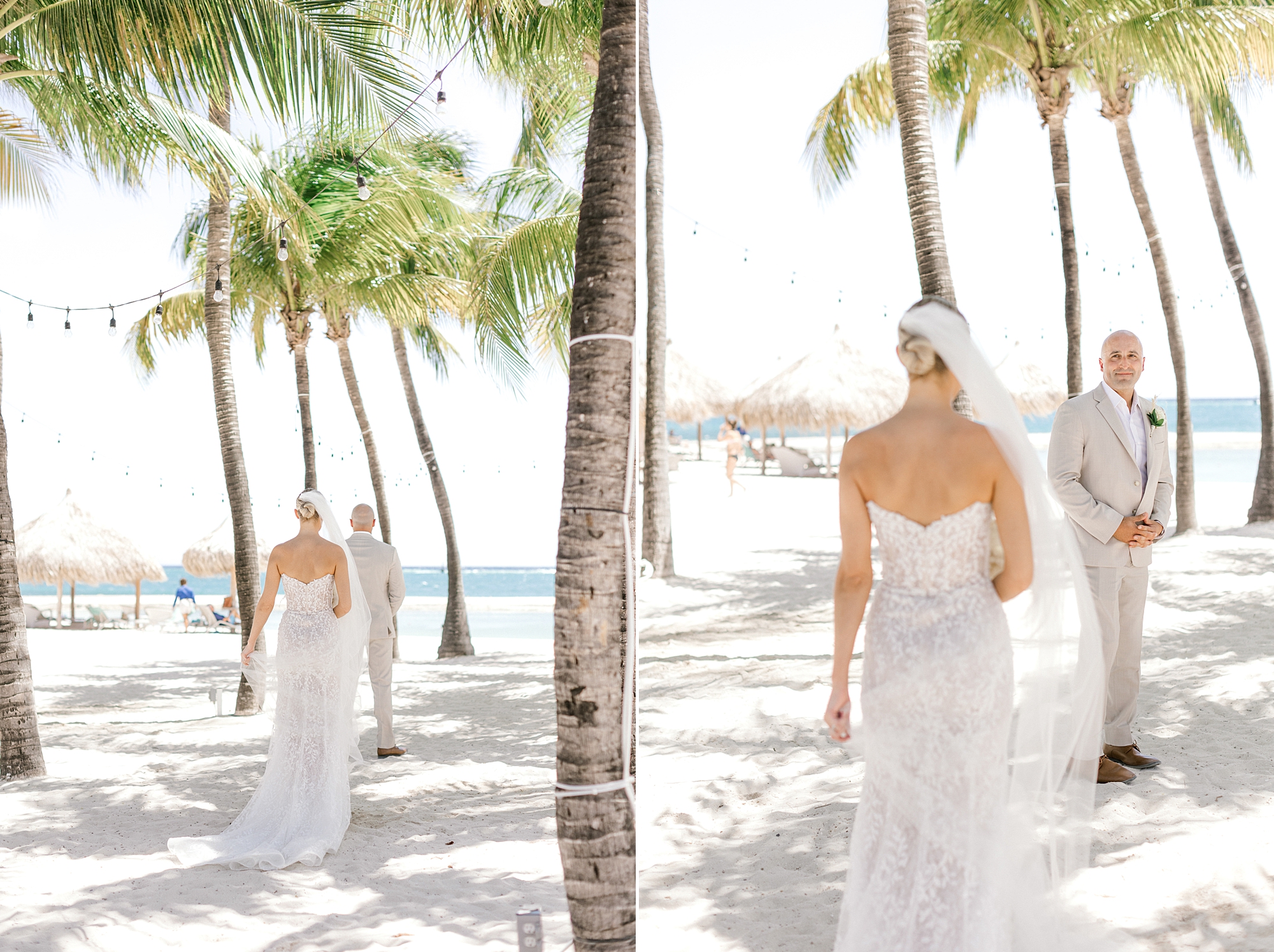 bride approaches groom for first look under palm trees outside the Renaissance Aruba hotel