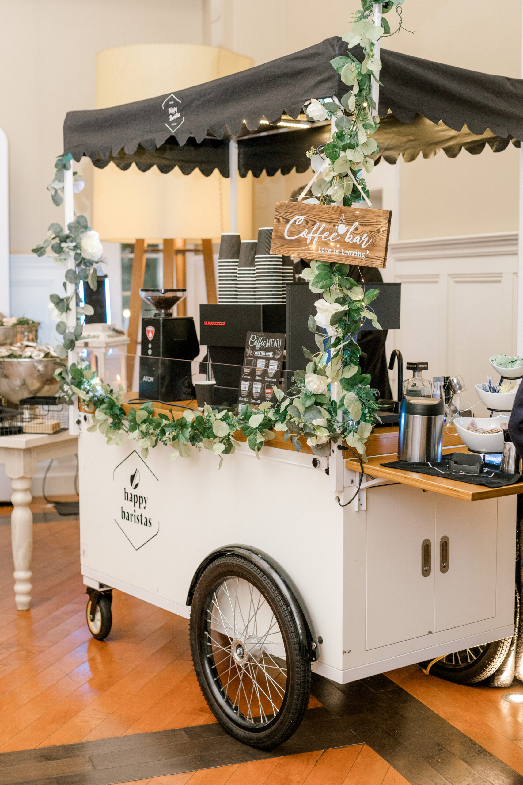 coffee cart with greenery on rails for summer wedding reception