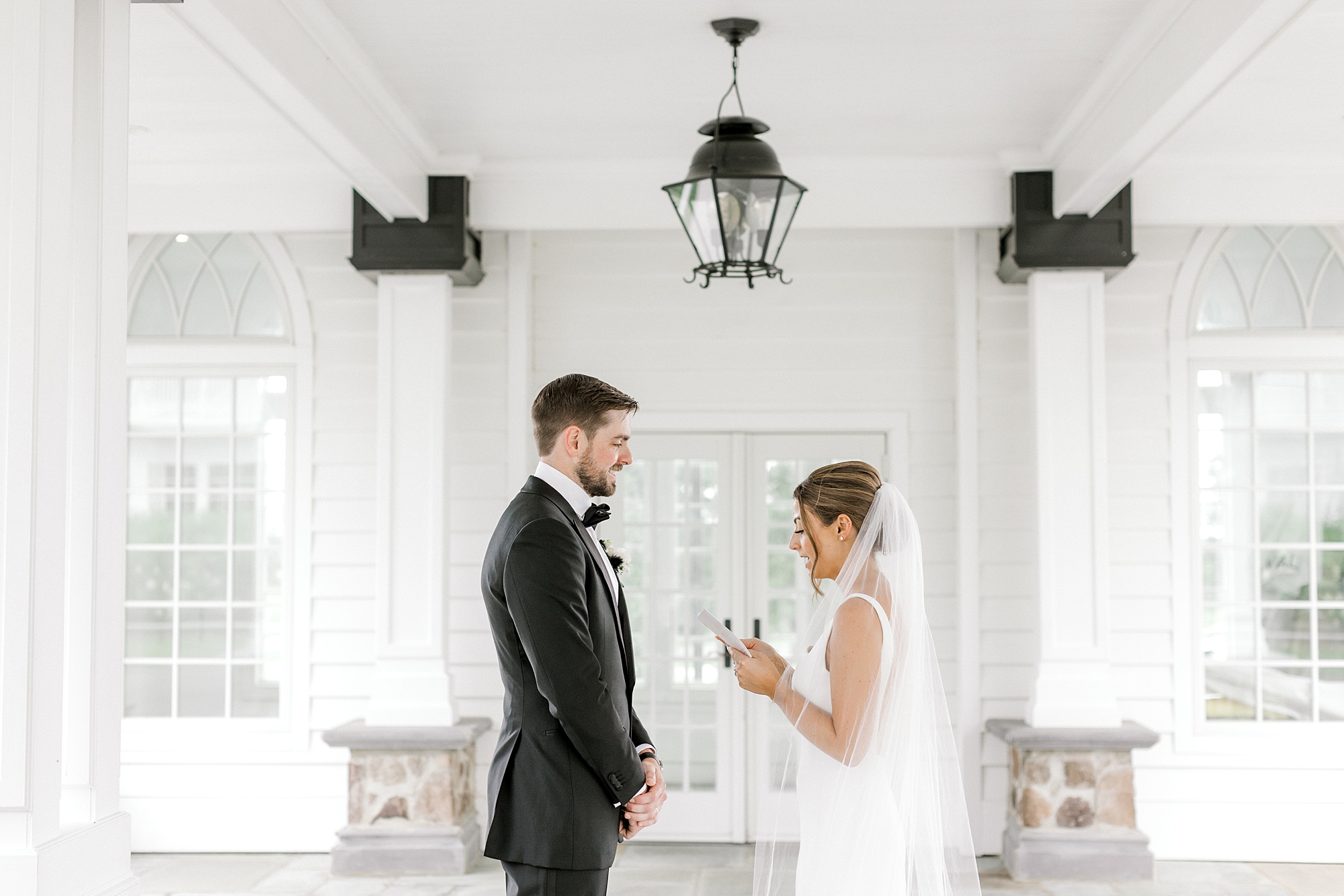 bride and groom read vows privately during first look at Ryland Inn