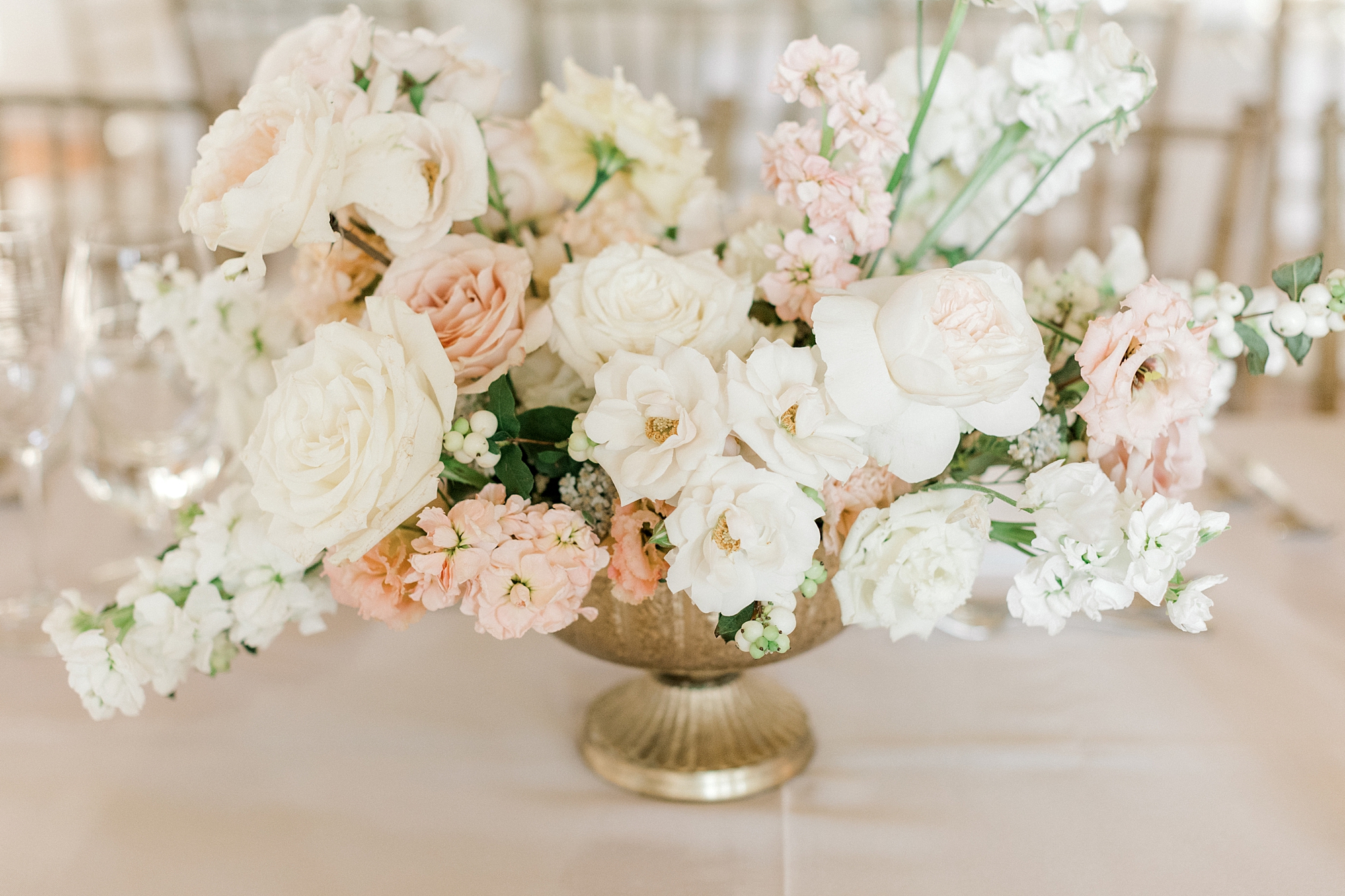 white and pink flower arrangements in gold vases at Ryland Inn