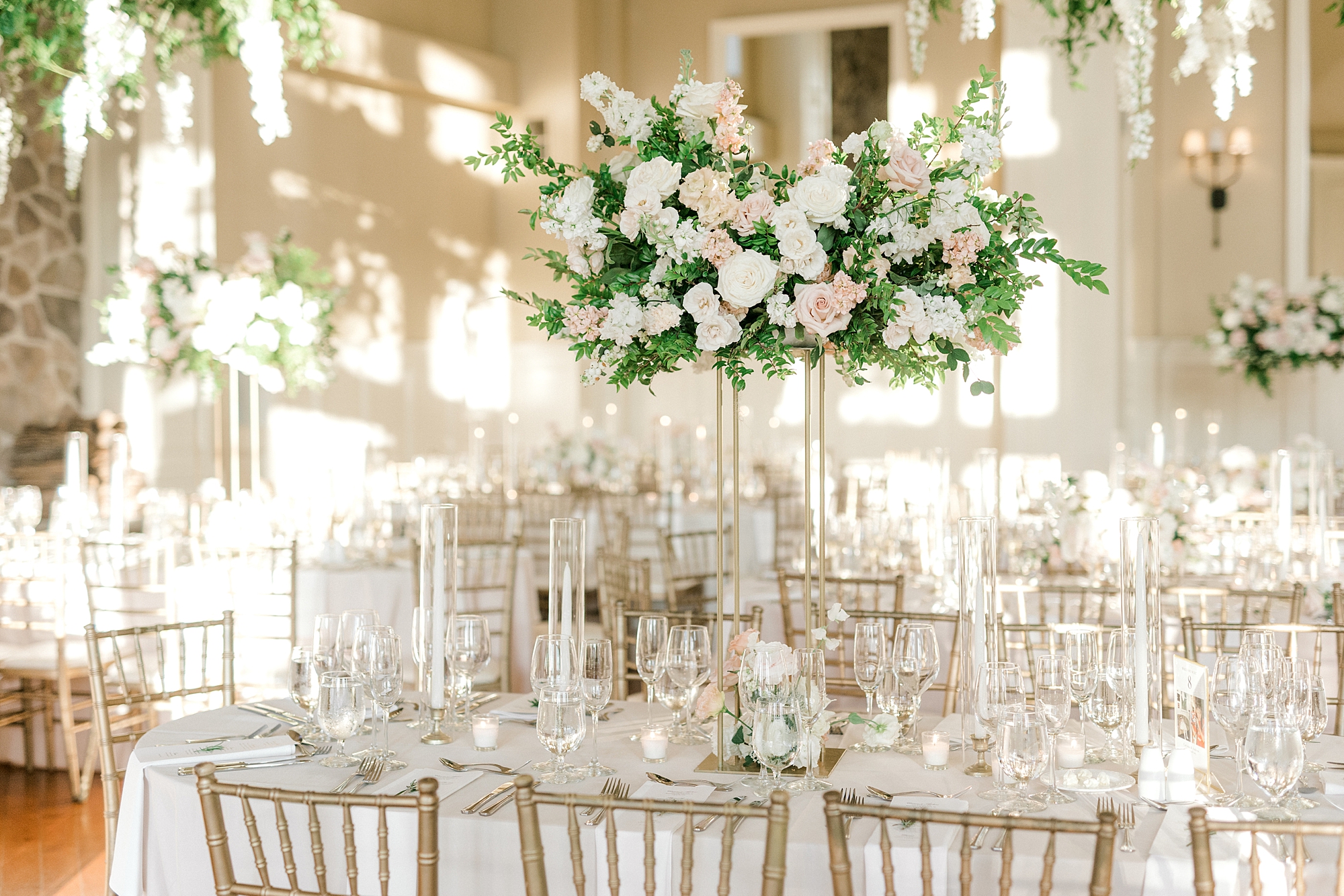 wedding reception with luxurious centerpieces of white and pink flowers