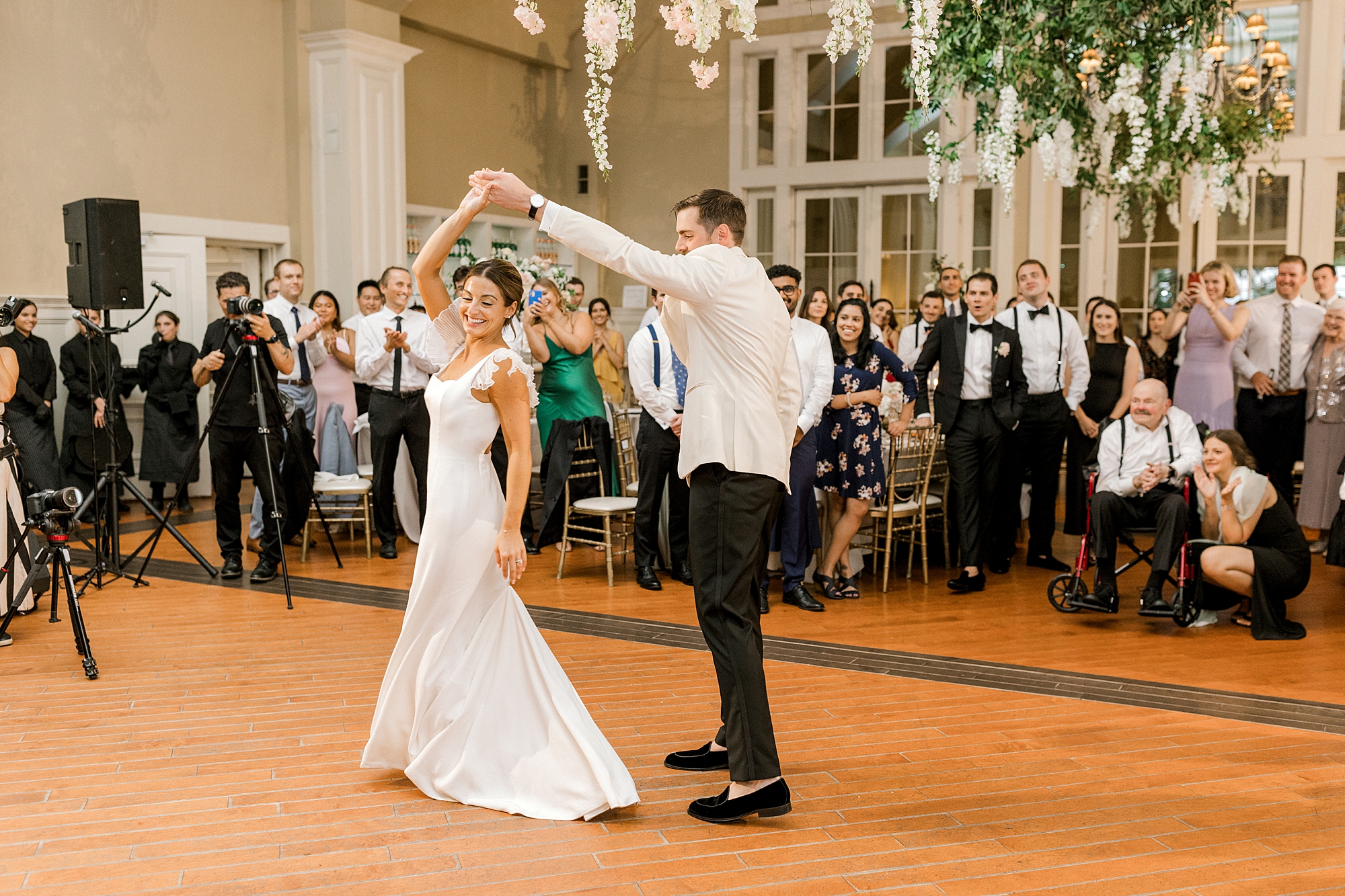 groom twirls bride during first dance at New Jersey wedding reception
