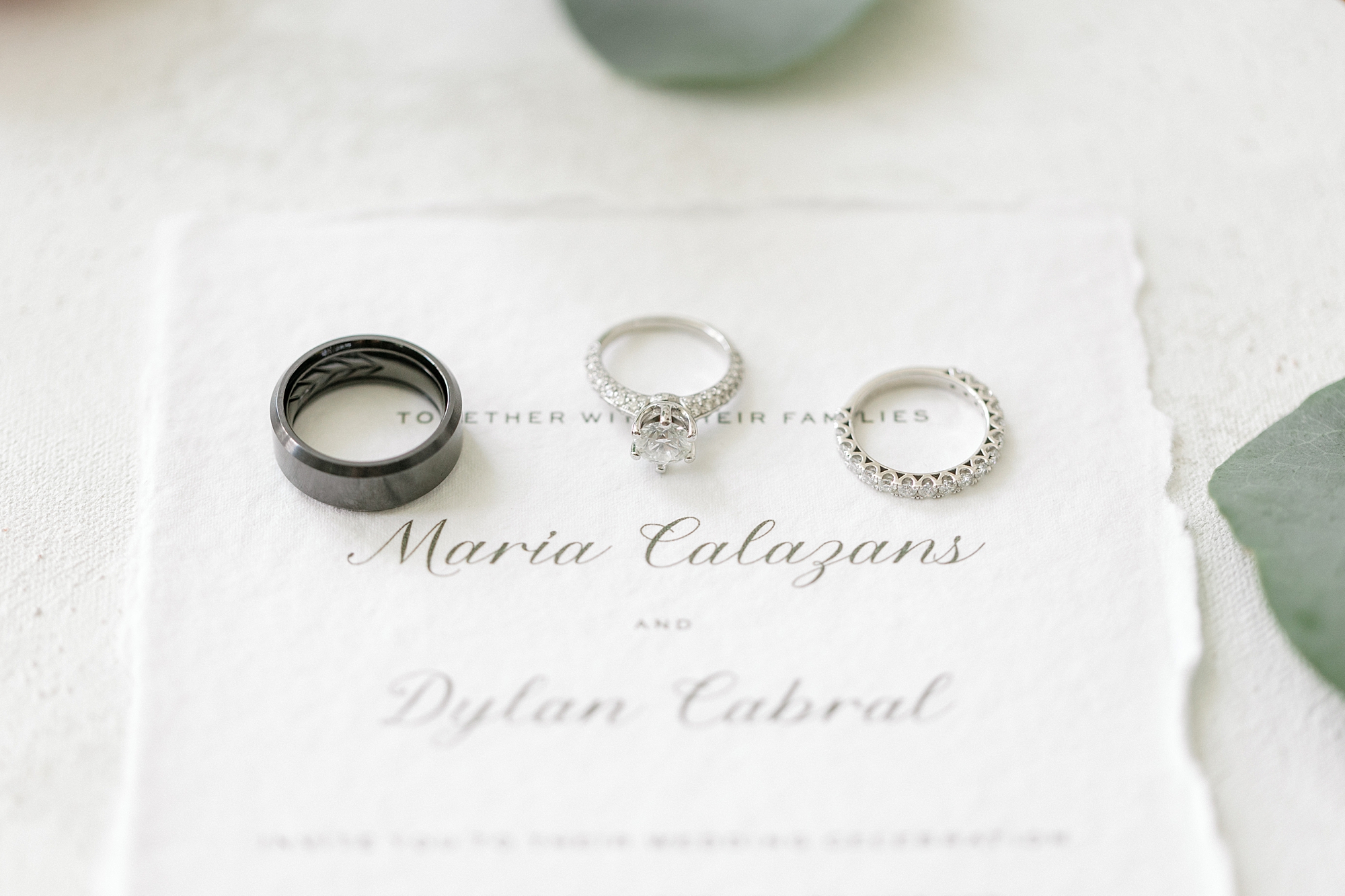three wedding rings lays on ivory stationery before NJ wedding day