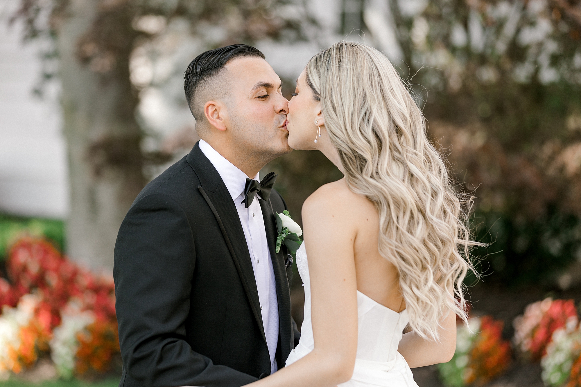 bride and groom kiss outside Ryland Inn before wedding