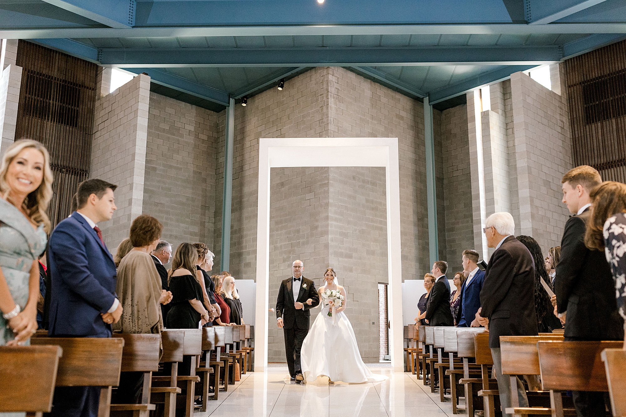 bride and father walk into church for traditional church wedding in New Jersey