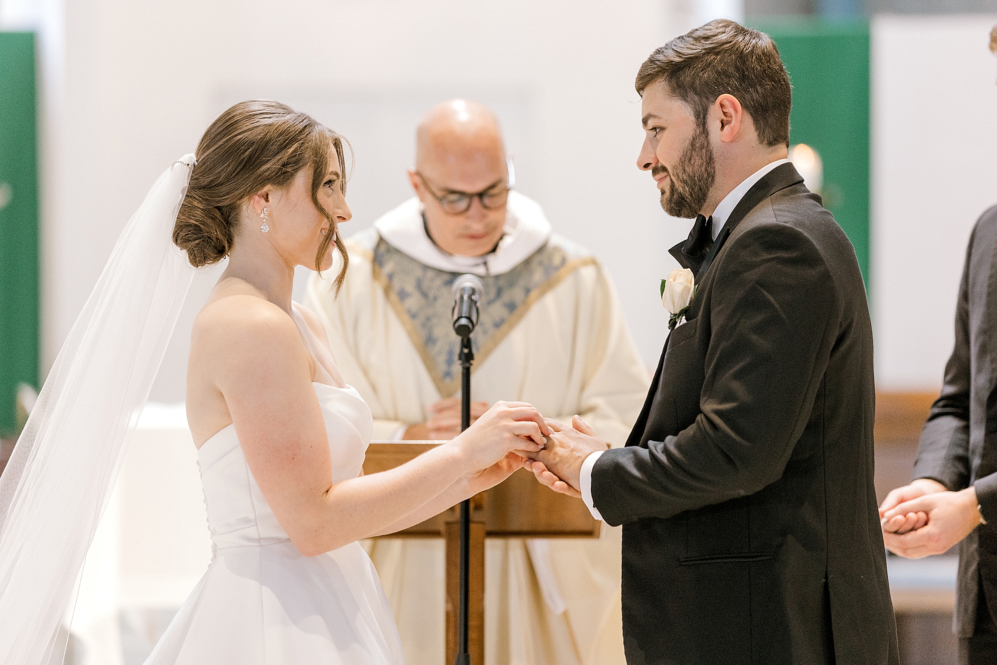 bride and groom hold hands exchanging vows during traditional church wedding in New Jersey