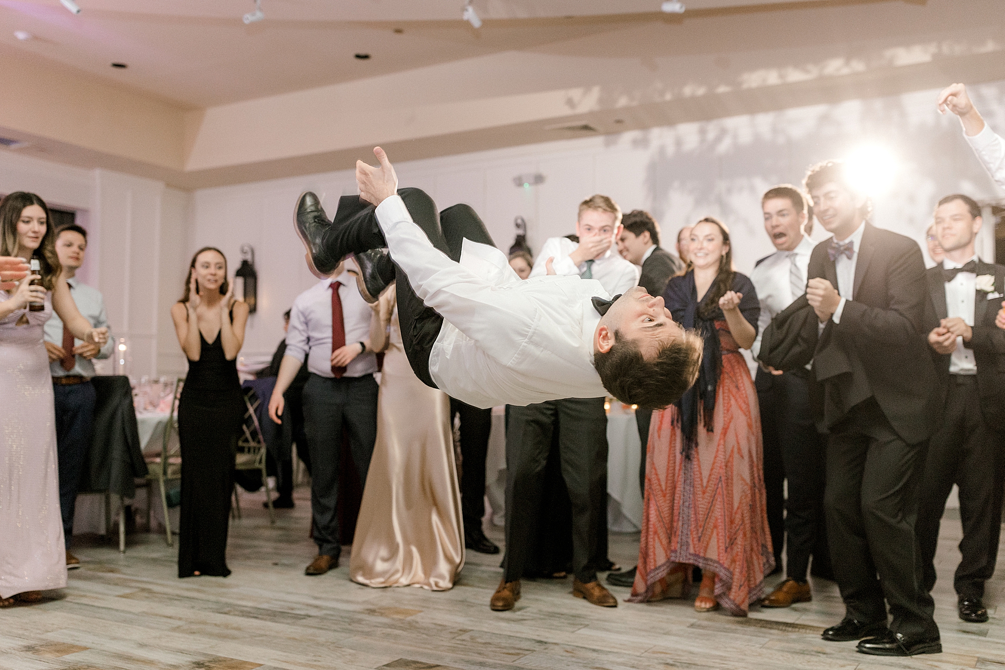 groom flips on dance floor during Hampton NJ wedding reception