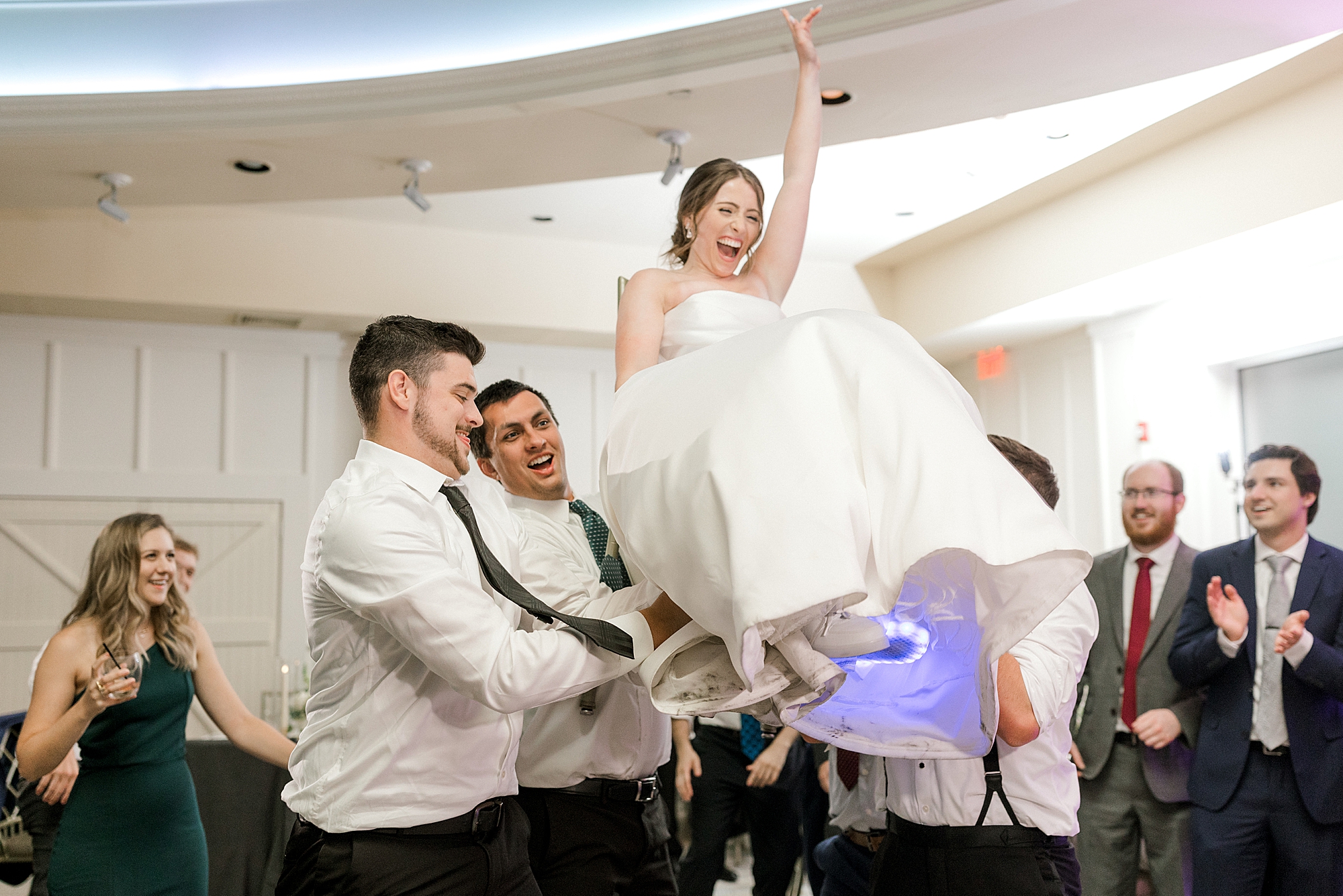 guests lift up bride during NJ wedding reception