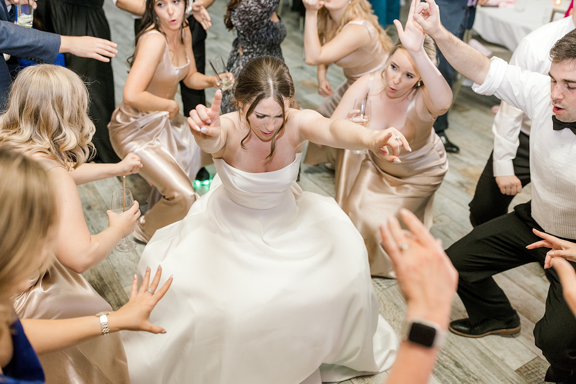 bride dances with bridesmaids during wedding reception in New Jersey