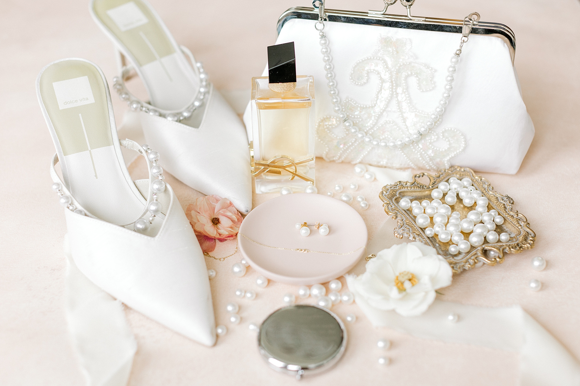 bride's white shoes, pearl earrings, and perfume for classic NJ wedding
