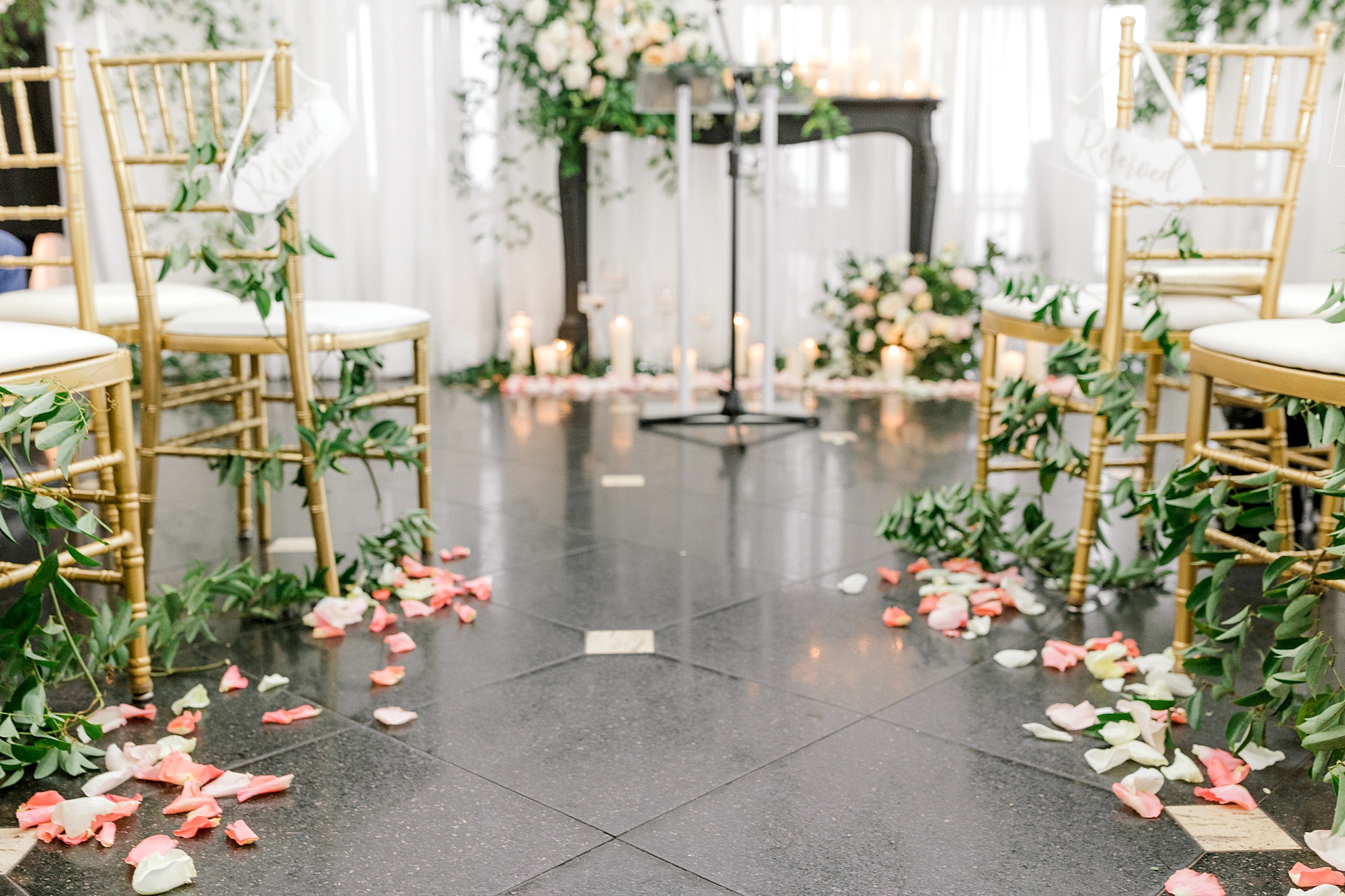 ceremony details with ivory candles and flower petals down aisle at Mallard Island Yacht Club