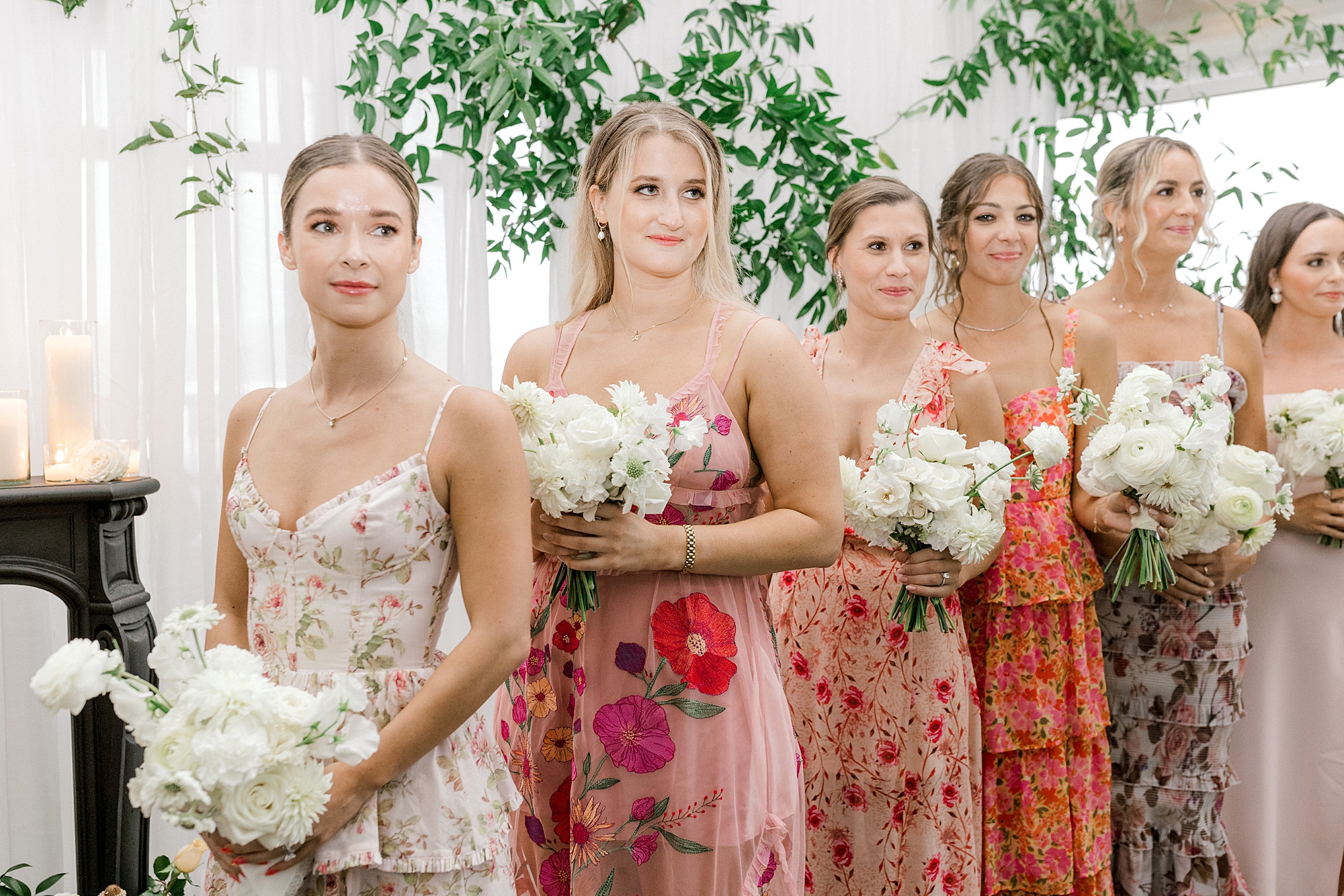 bridesmaids with mismatched pink and orange gowns at Mallard Island Yacht Club watch bride enter