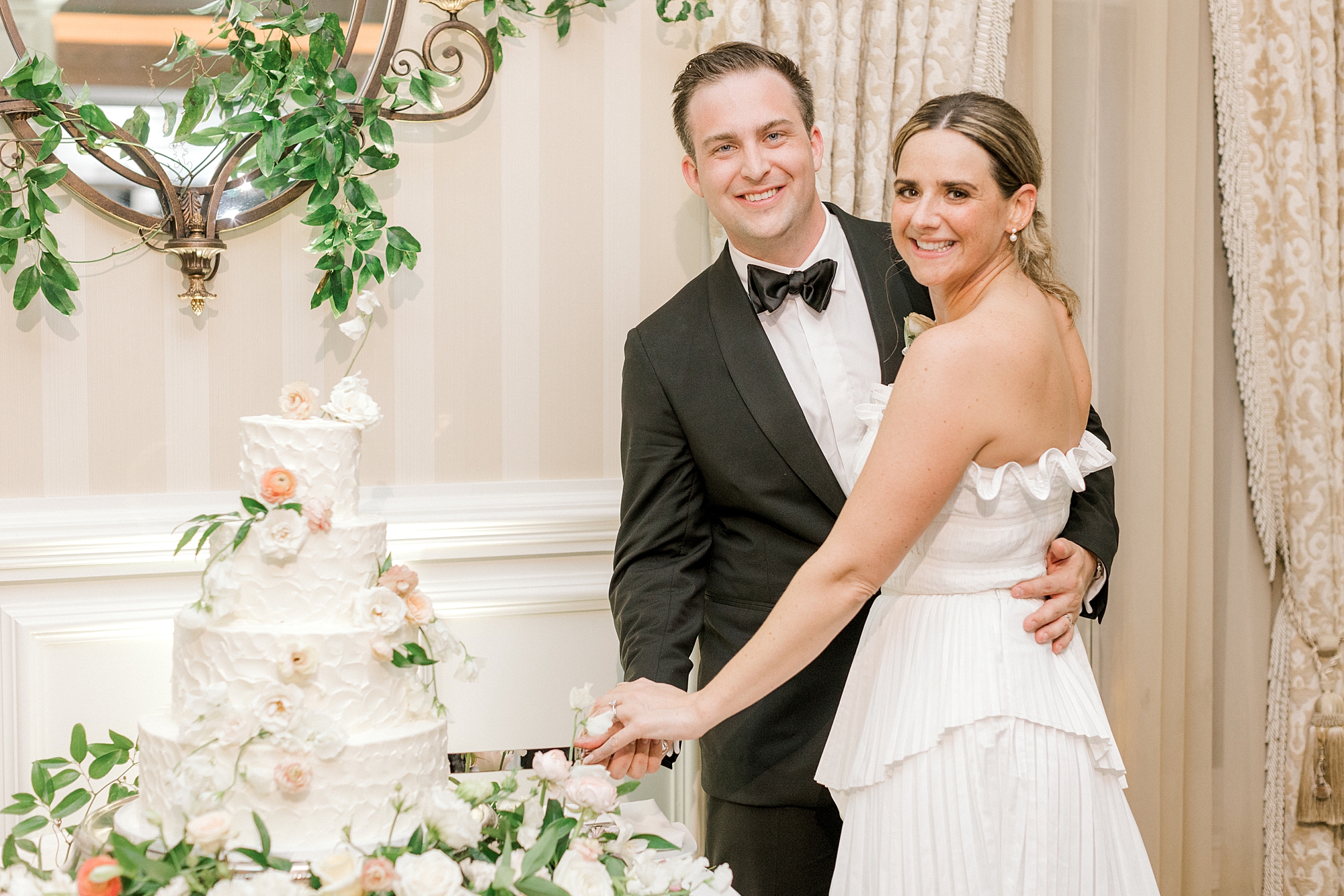 bride and groom hug smiling near cake at Long Beach Island wedding reception