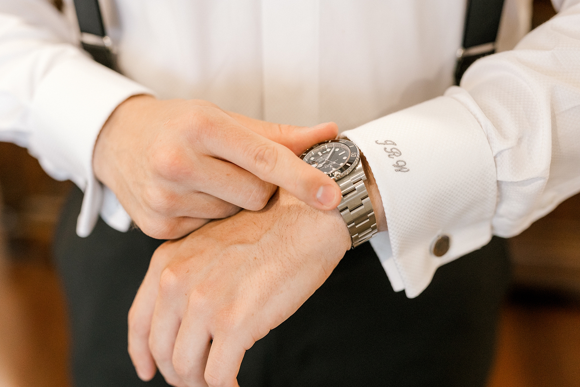 groom adjusts new watch on wrist during NJ wedding day