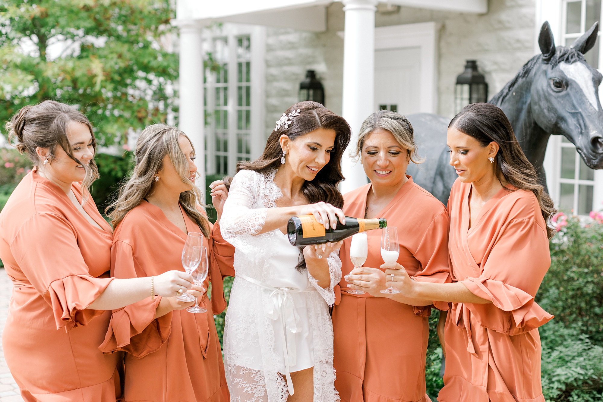 bride pours champagne on New Jersey wedding day