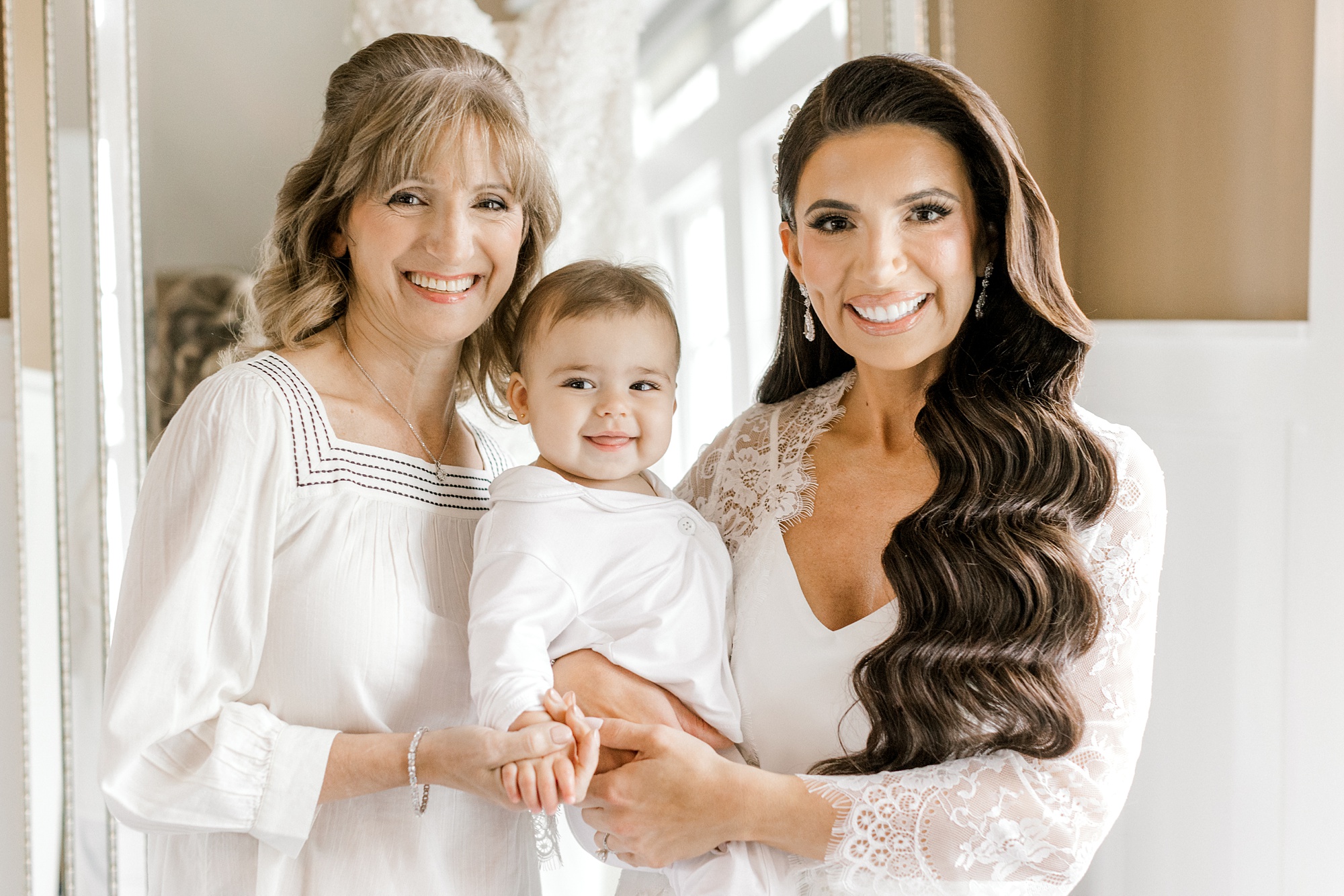 bride poses with mother and daughter in room at Ryland Inn