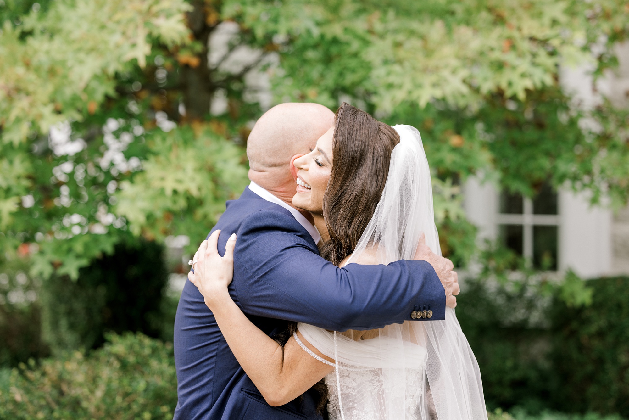 bride and dad hug during first look at New Jersey wedding venue