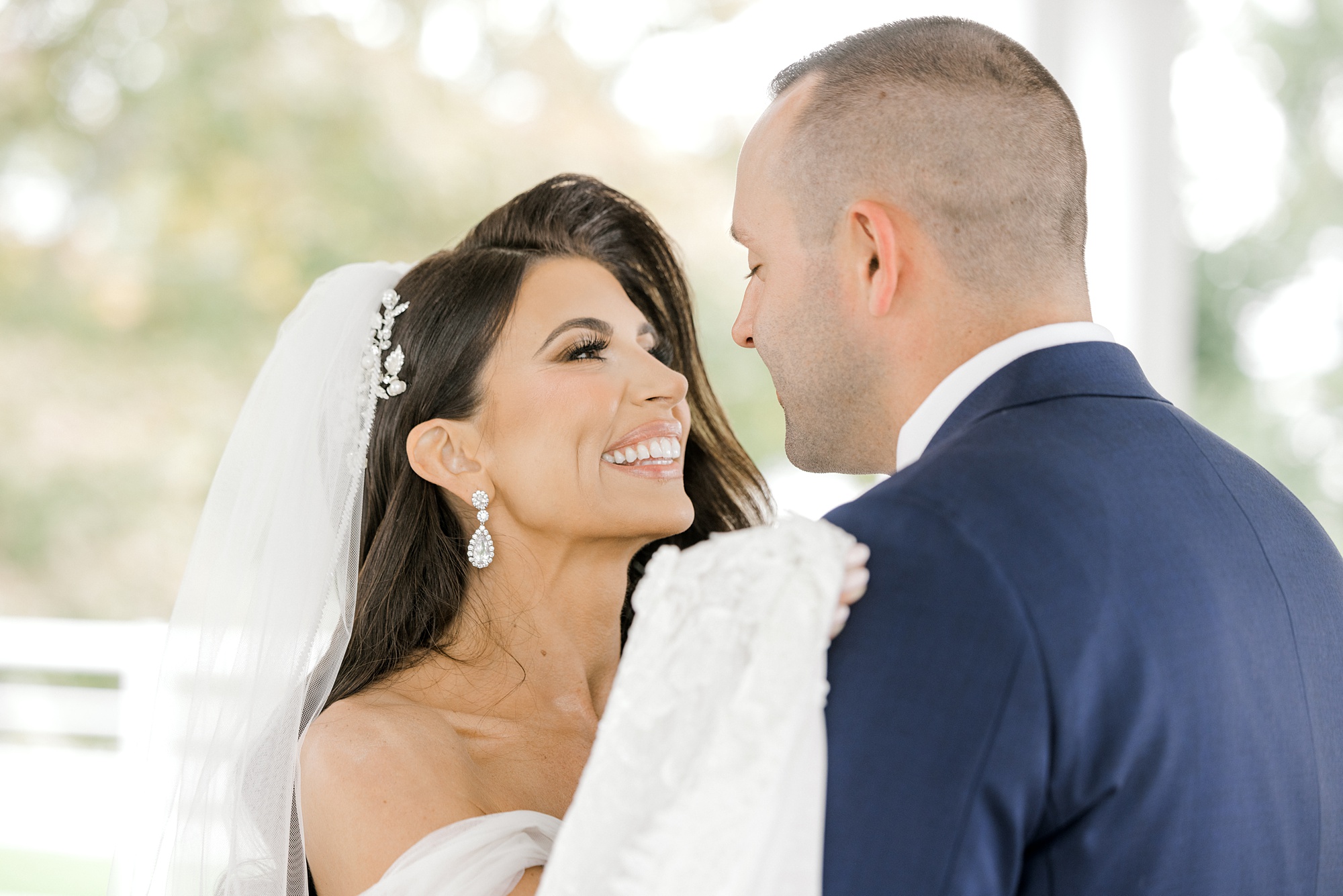 bride looks up at groom grinning in New Jersey at Ryland Inn
