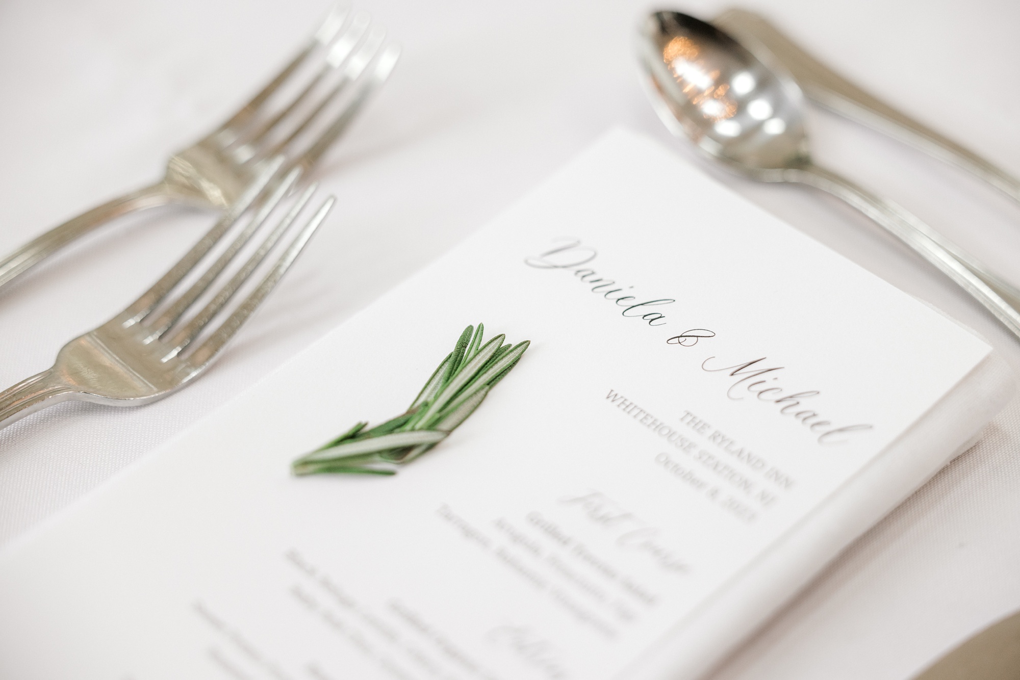 place setting with rosemary clippings on menu for wedding reception at Ryland Inn