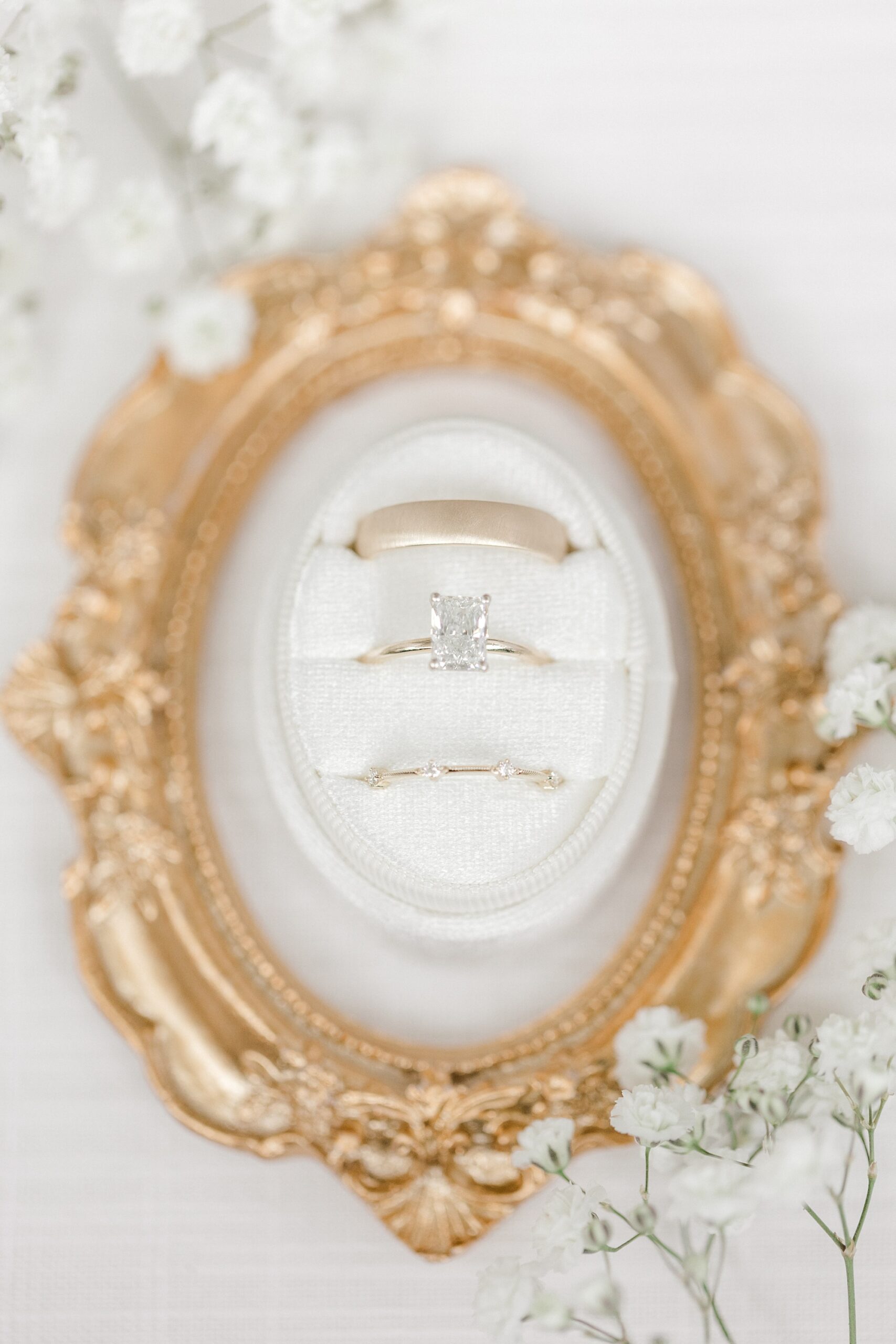 wedding rings rest on gold plate at Fiddler's Elbow Country Club