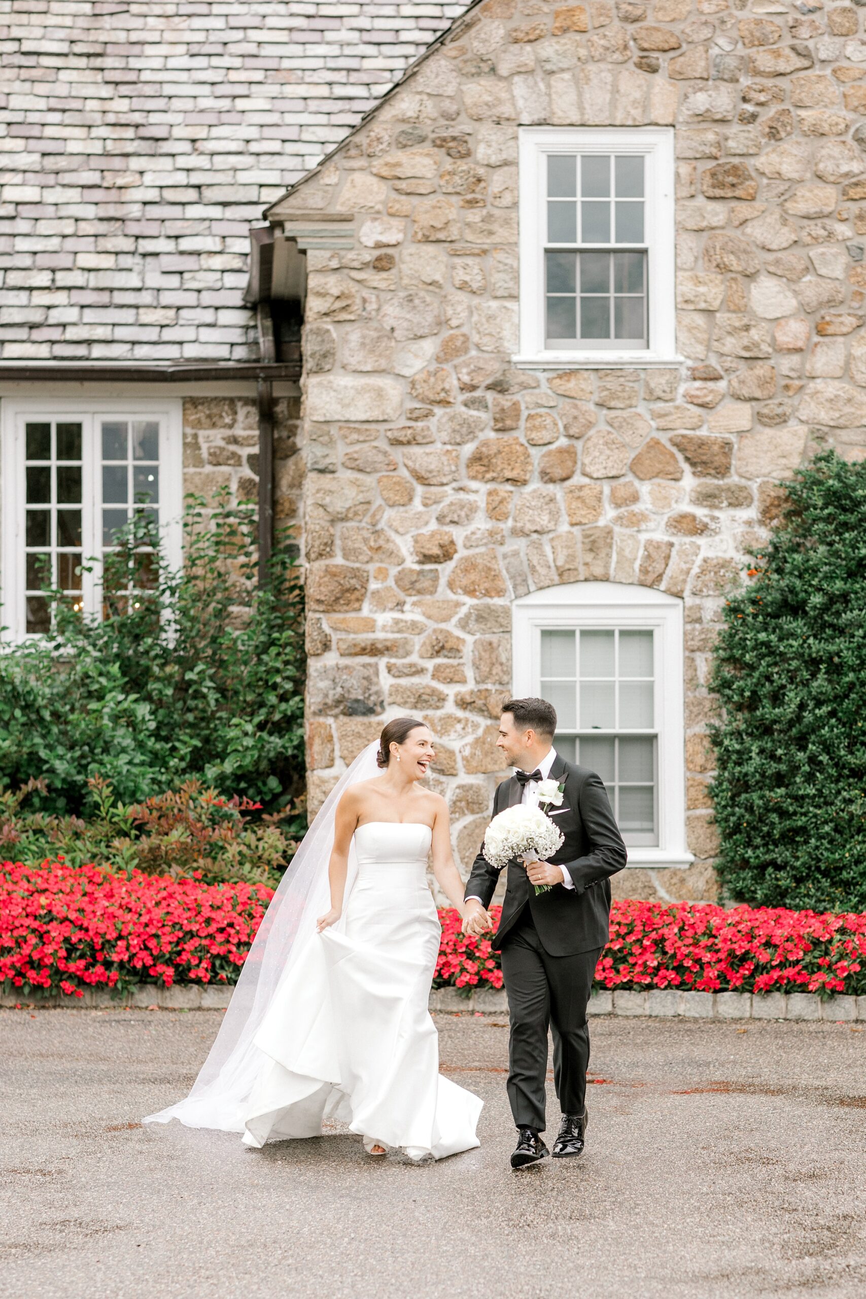 newlyweds hold hands walking on pathway at Fiddler’s Elbow Country Club 
