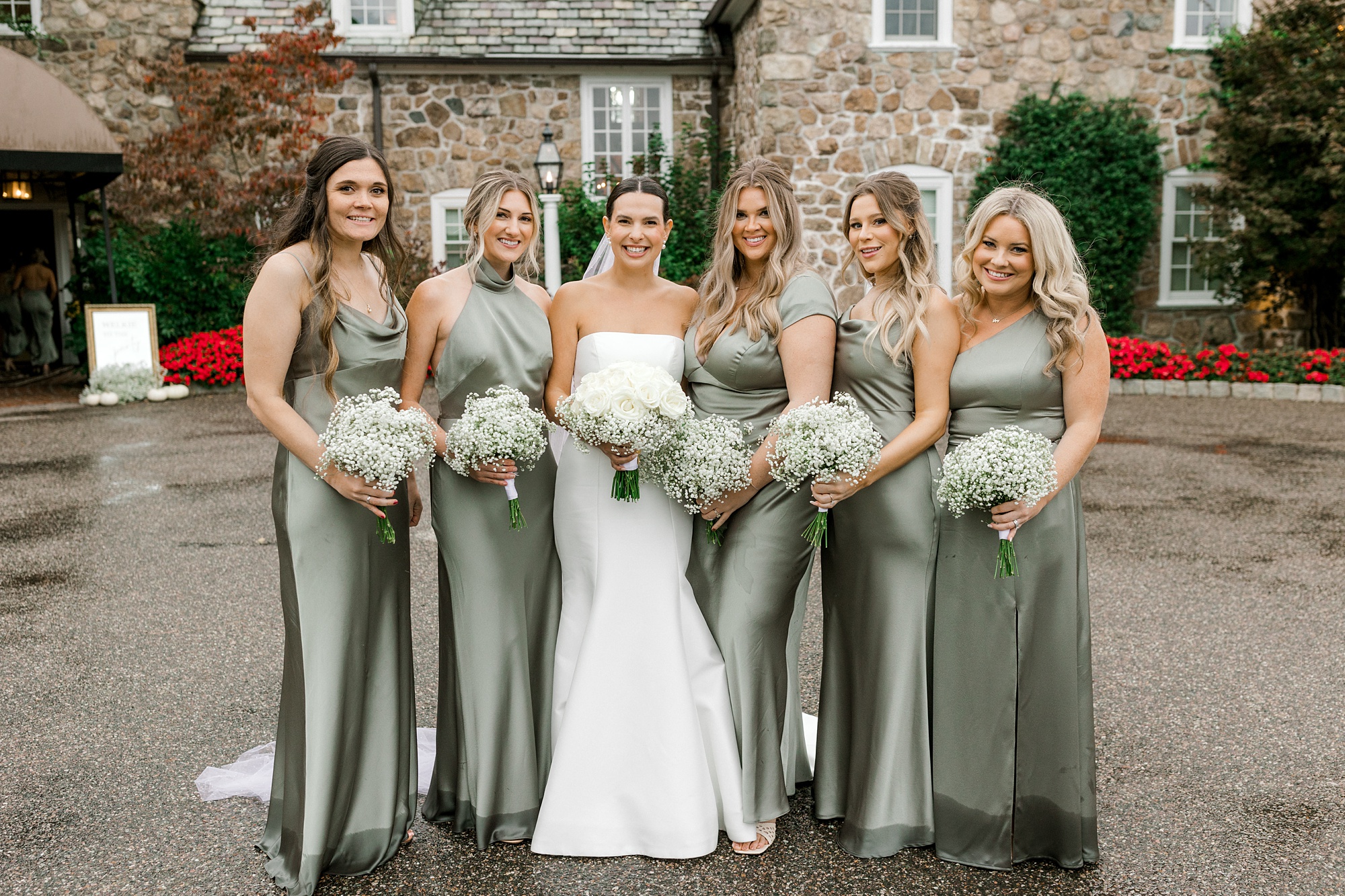 bride poses with bridesmaids in silk dresses
