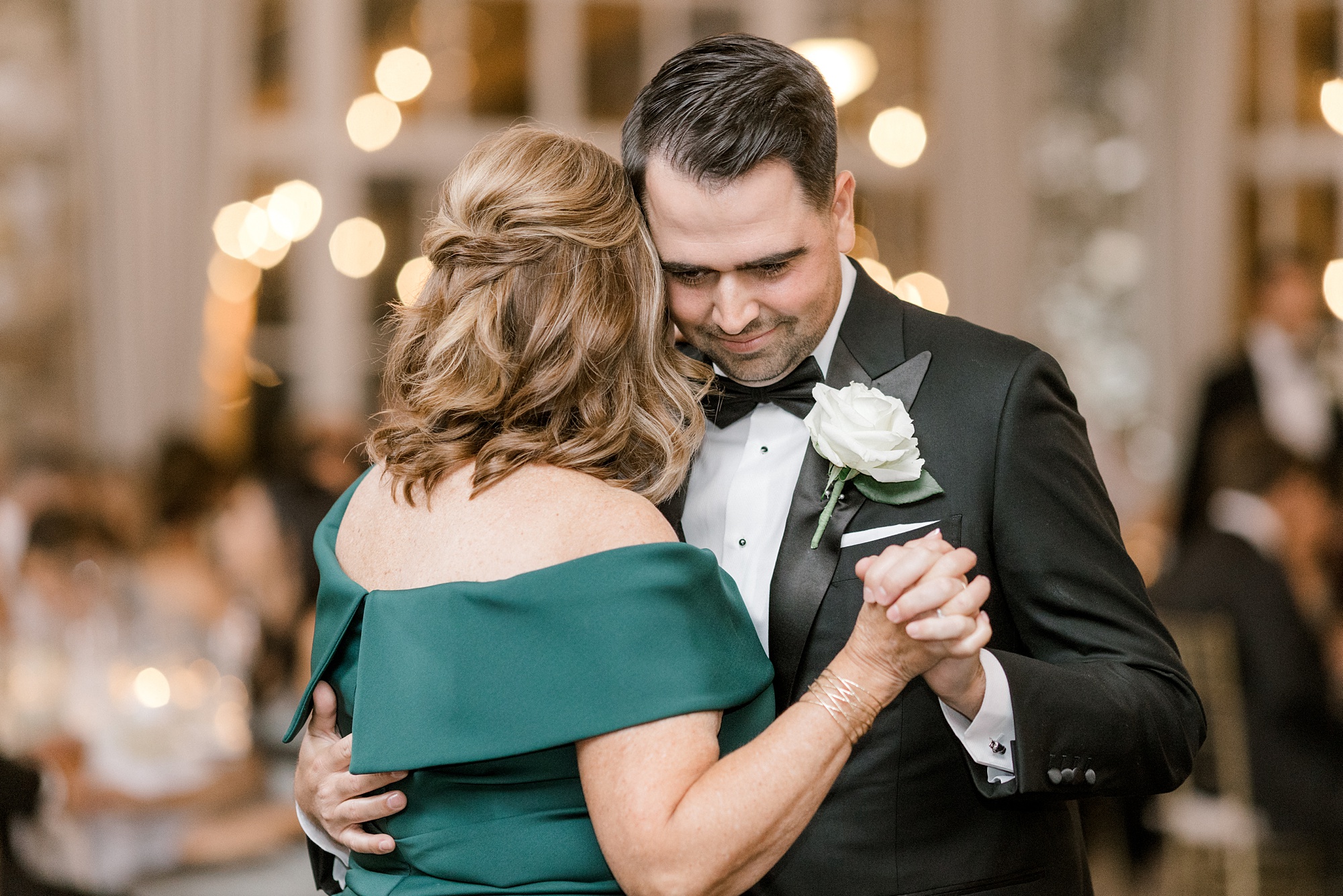 groom hugs mom leaning into her for a dance at Fiddler's Elbow Country Club