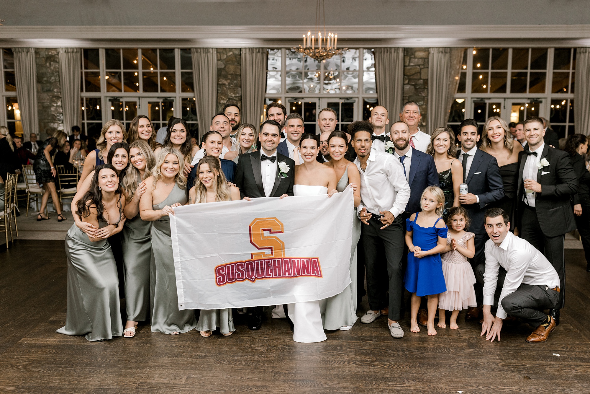 newlyweds pose with wedding guests from Susquehanna