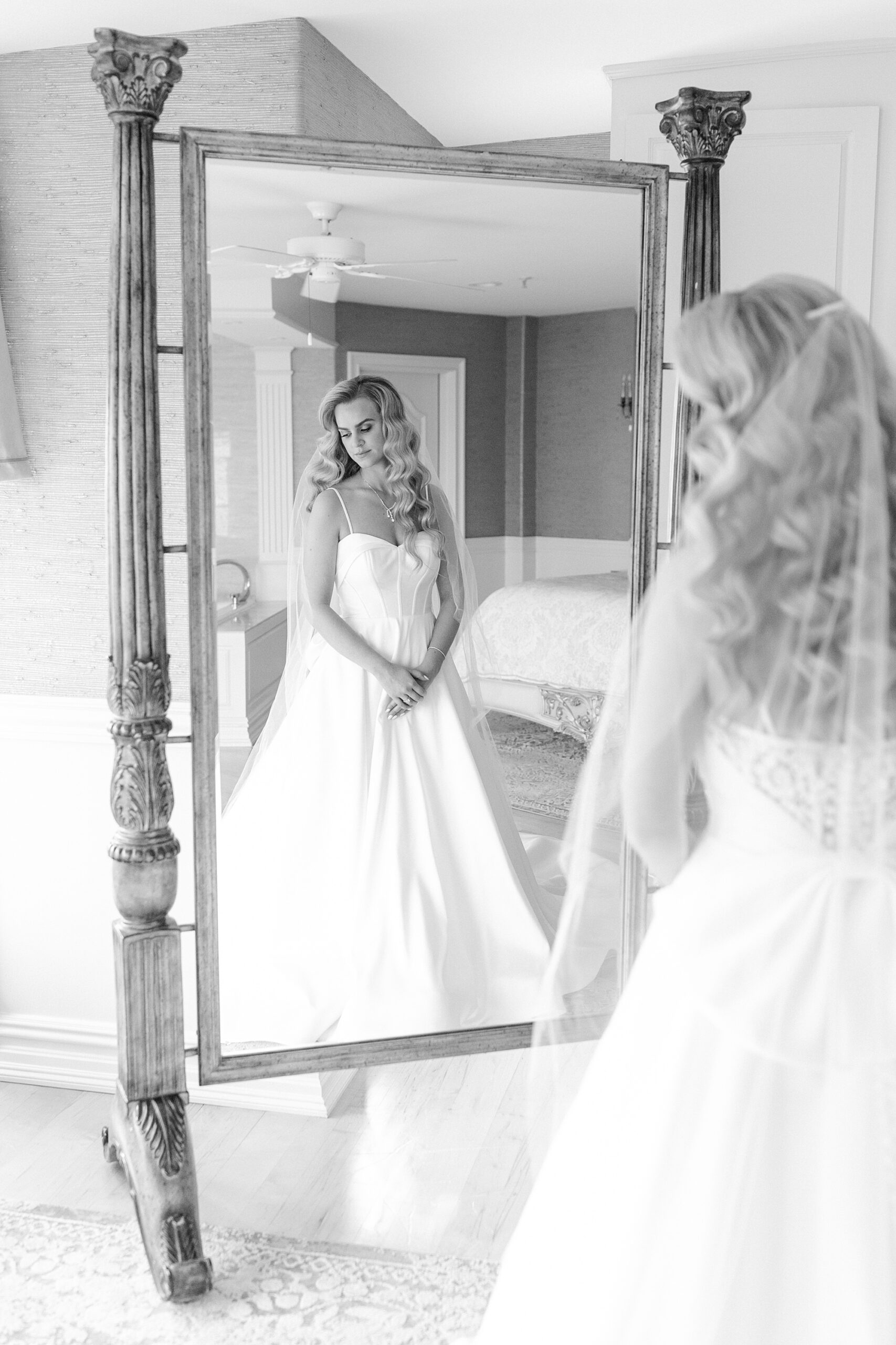 bride stands in front of full-length mirror in bridal suite at Bonnet Island Estate