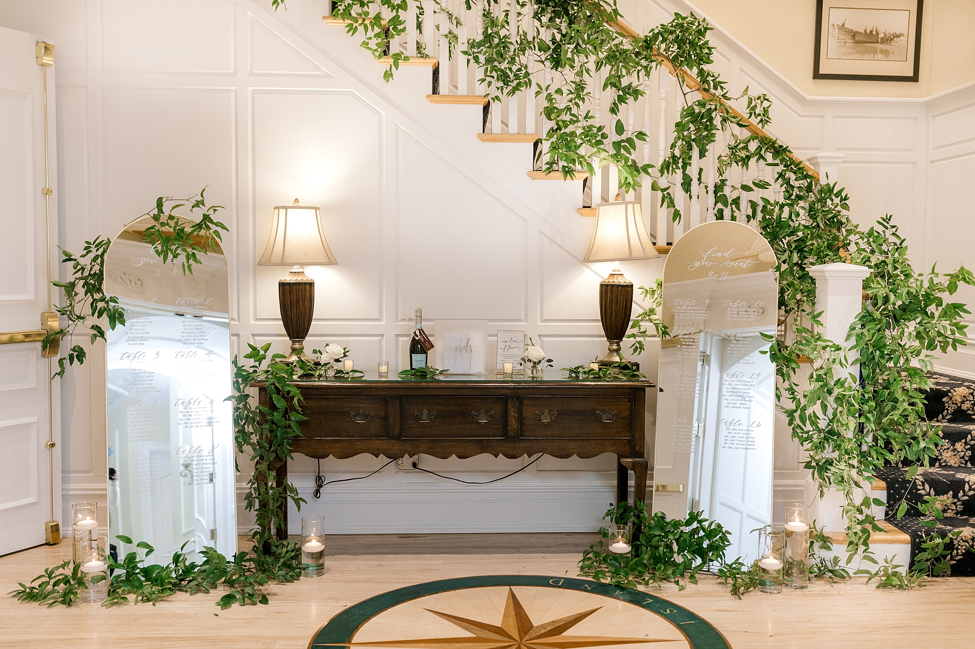 welcome table with greenery down staircase in lobby of Bonnet Island Estate