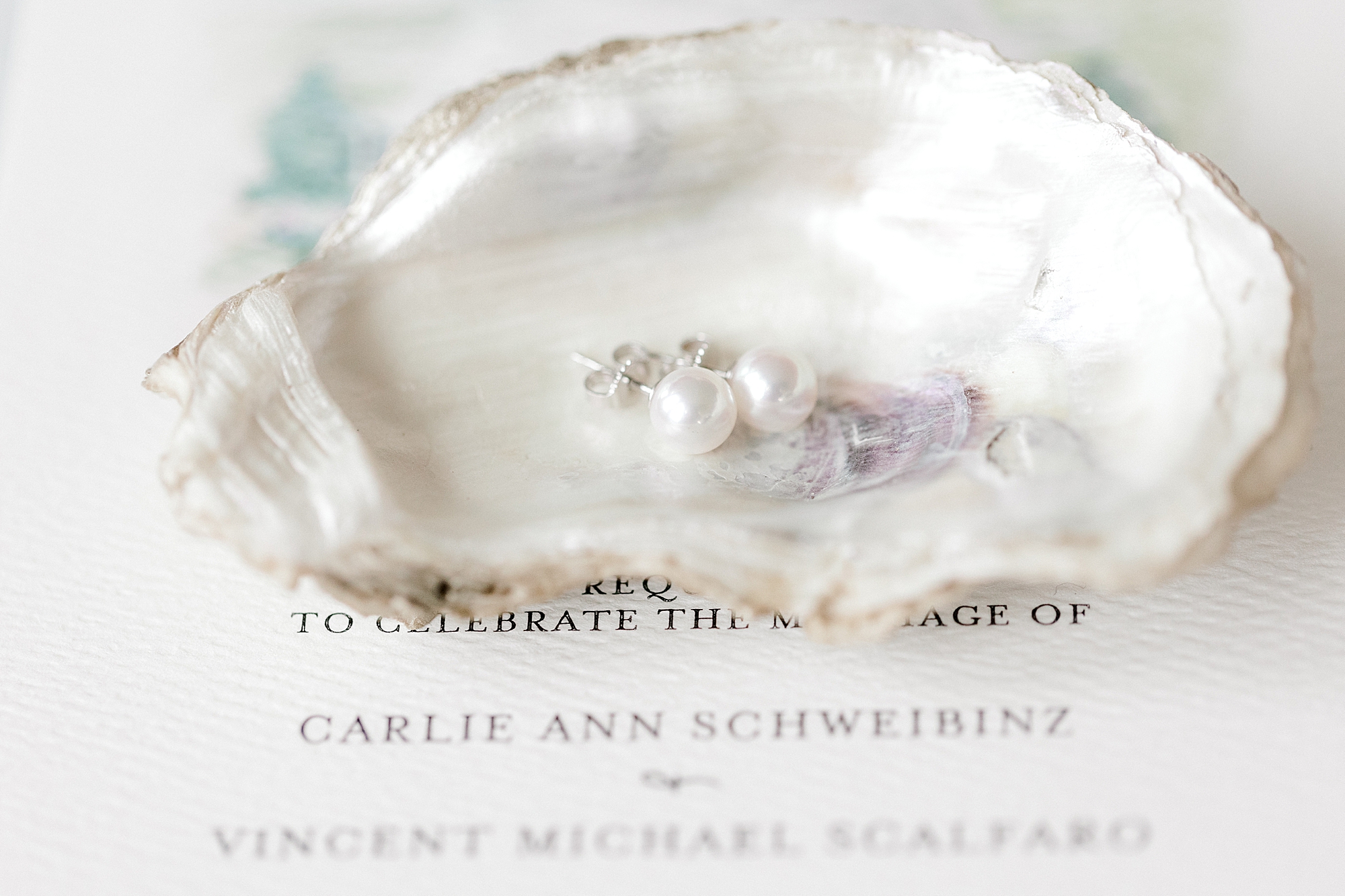 pearl and silver earrings lay in oyster shell before coastal inspired wedding at Bonnet Island Estate