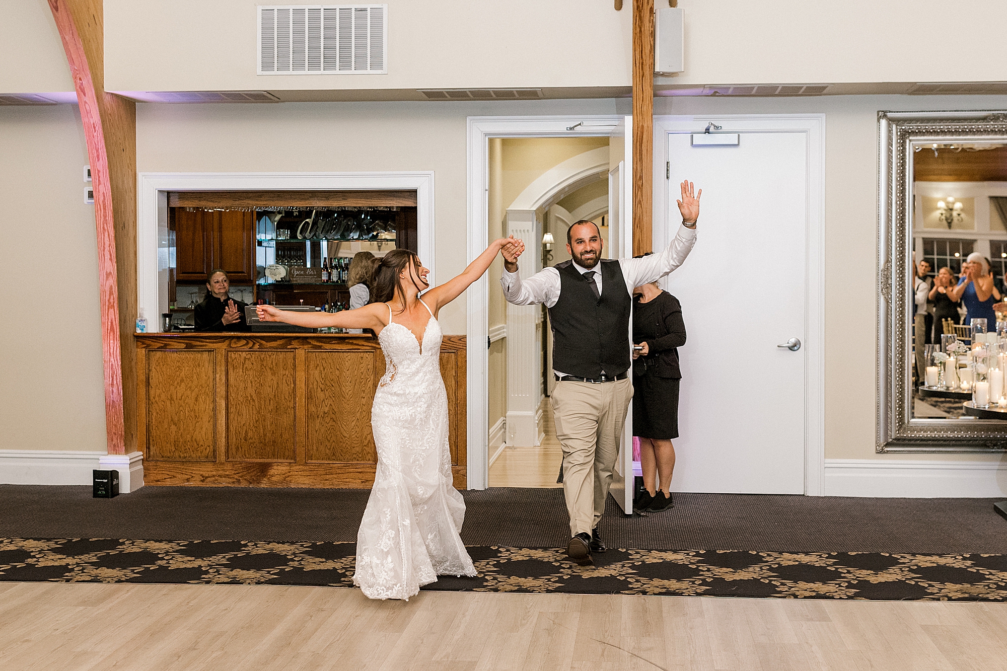 bride and groom cheer entering LBI wedding reception