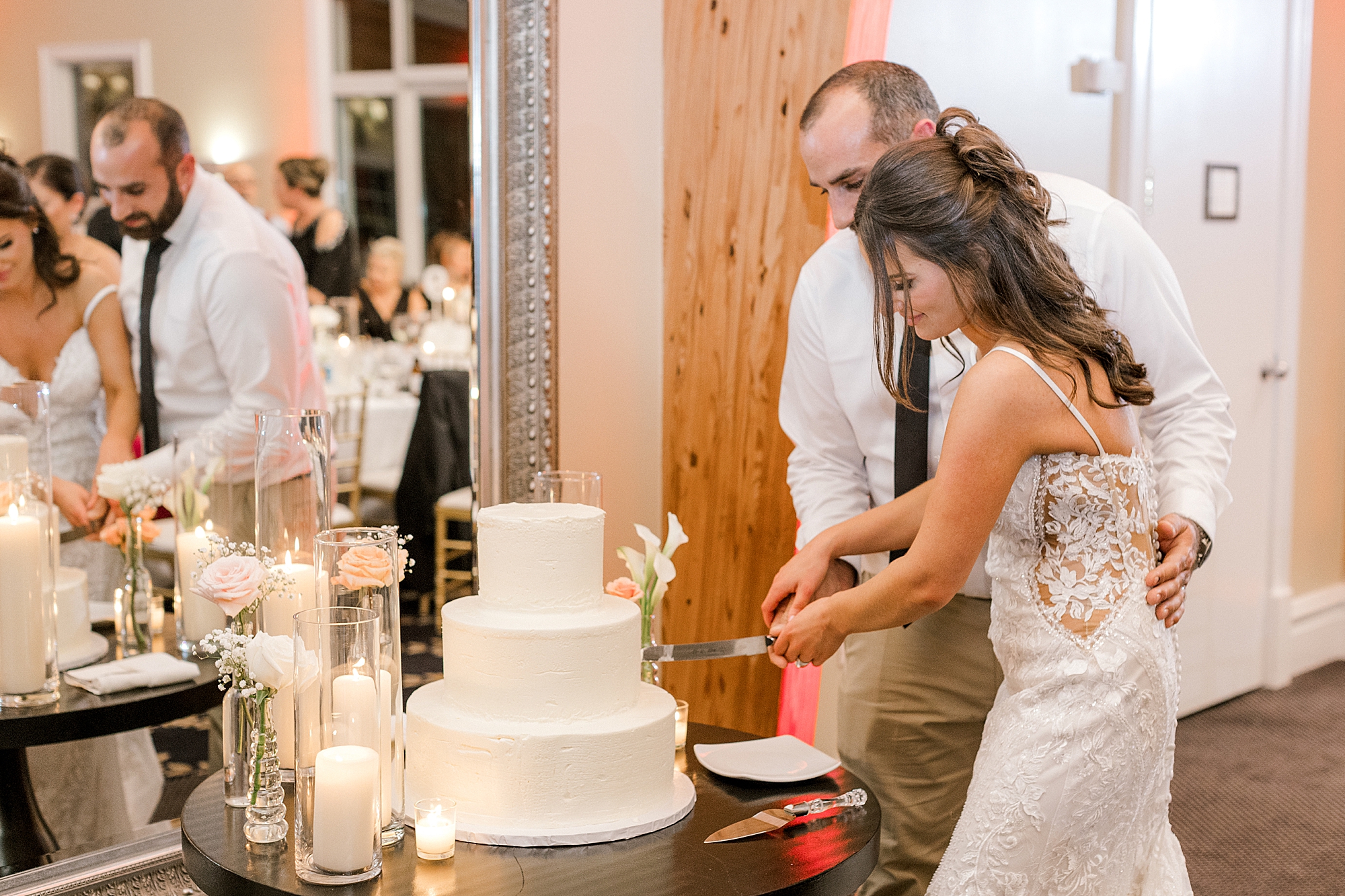 newlyweds cut wedding cake at LBI wedding reception