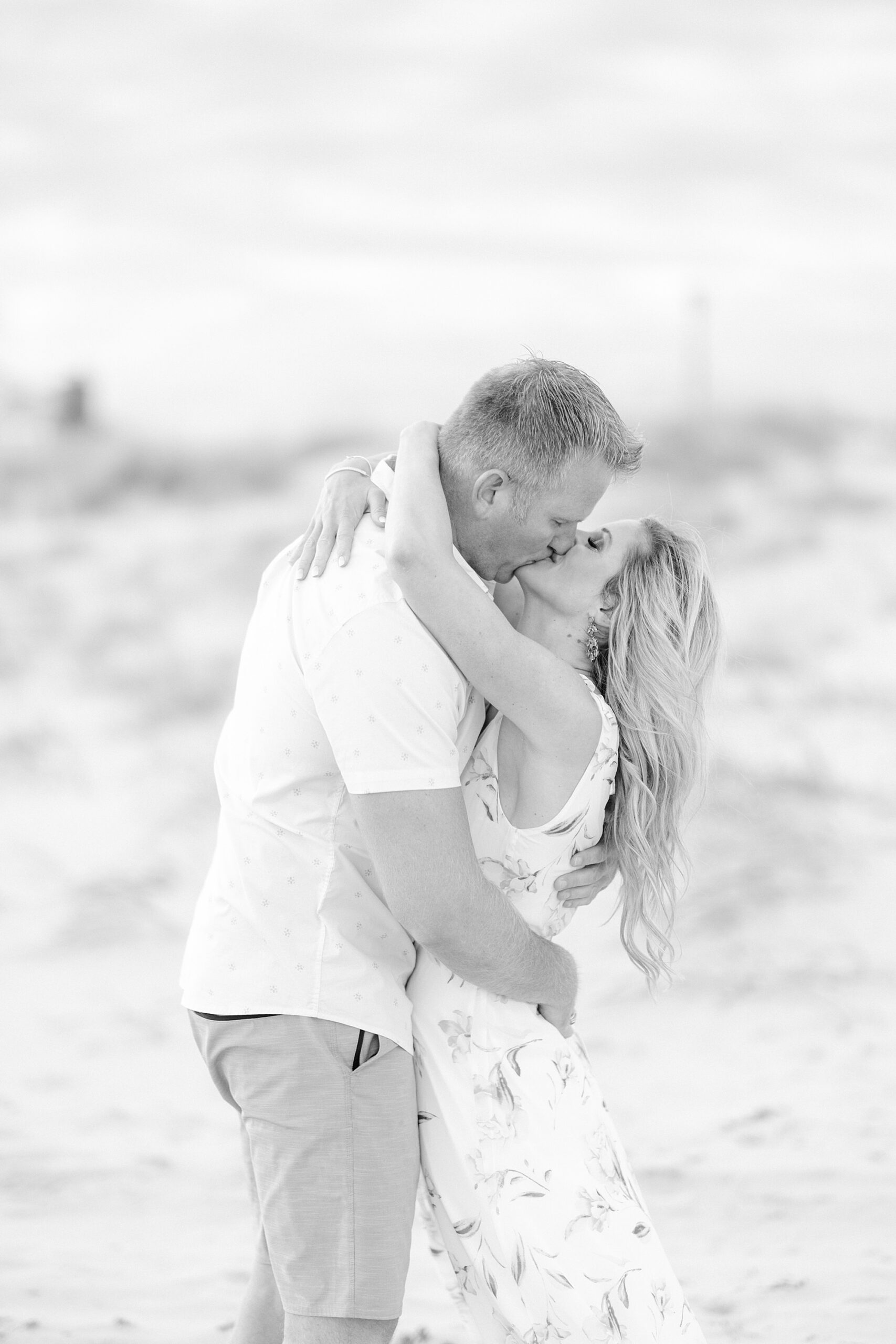 man and woman kiss on Brant Beach
