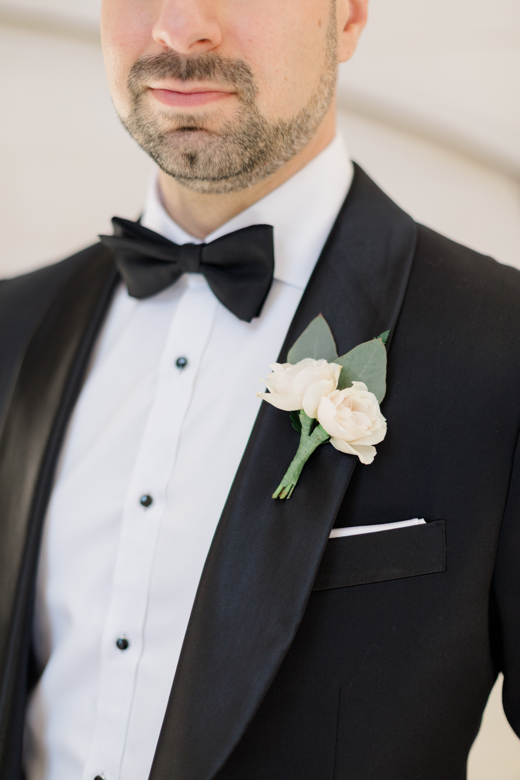 Groom with tux and boutonniere in Lakewood Ranch Golf & Country Club suite