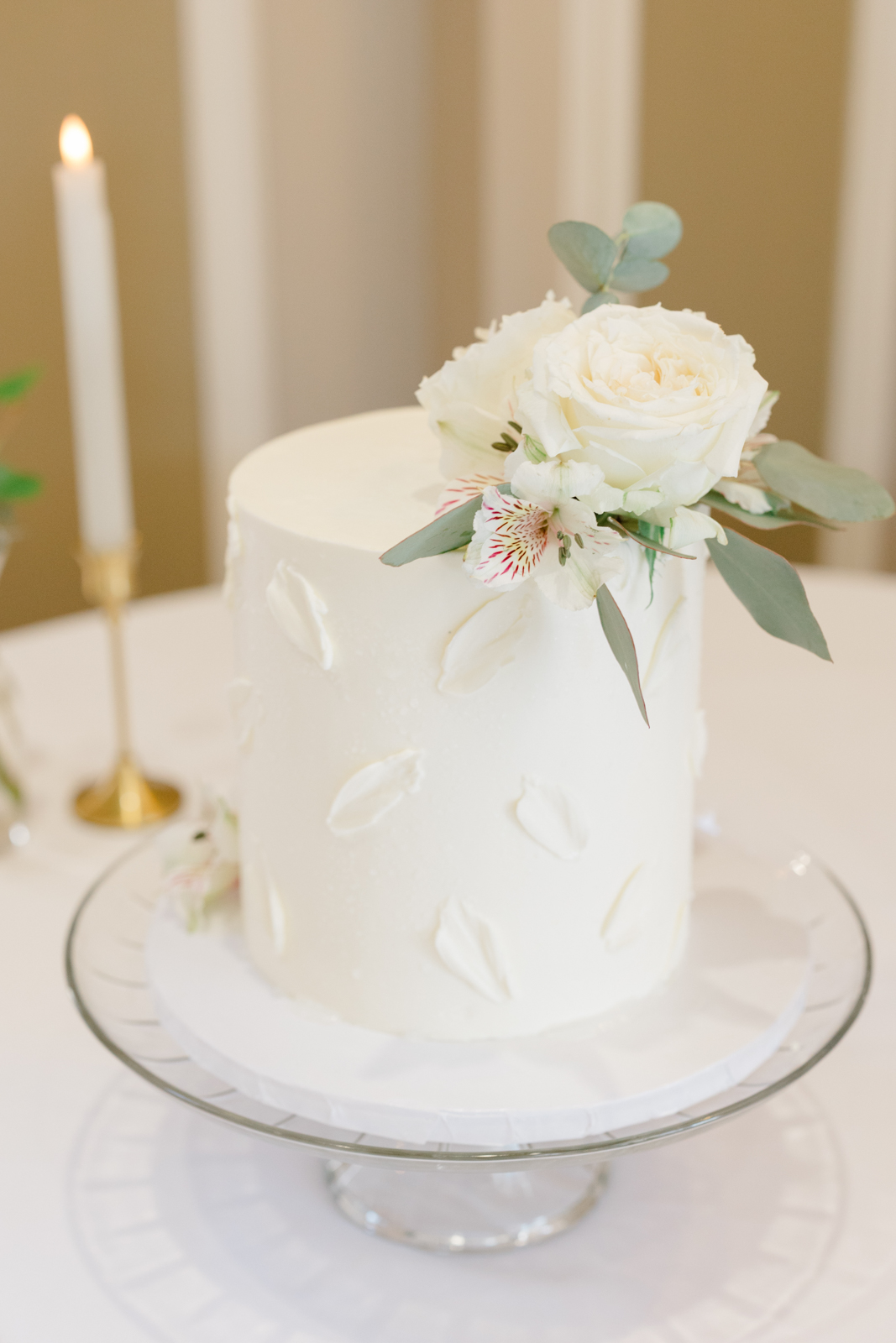 Small white wedding cake with flowers on top