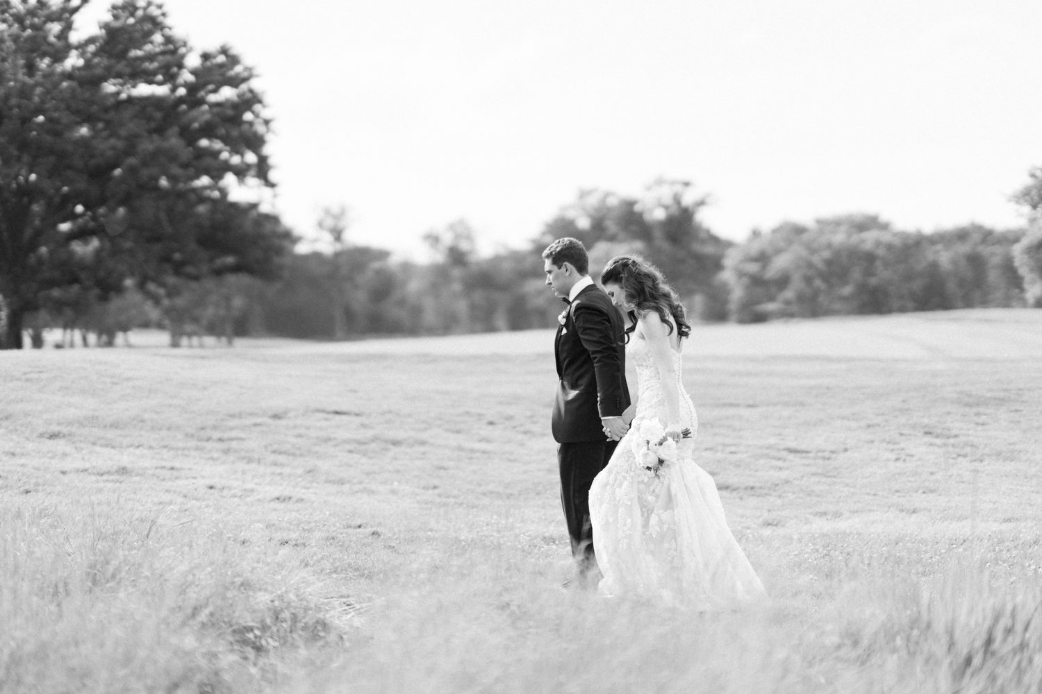 Black and white photo of Abby and Will walking the golf course, NJ wedding photographer