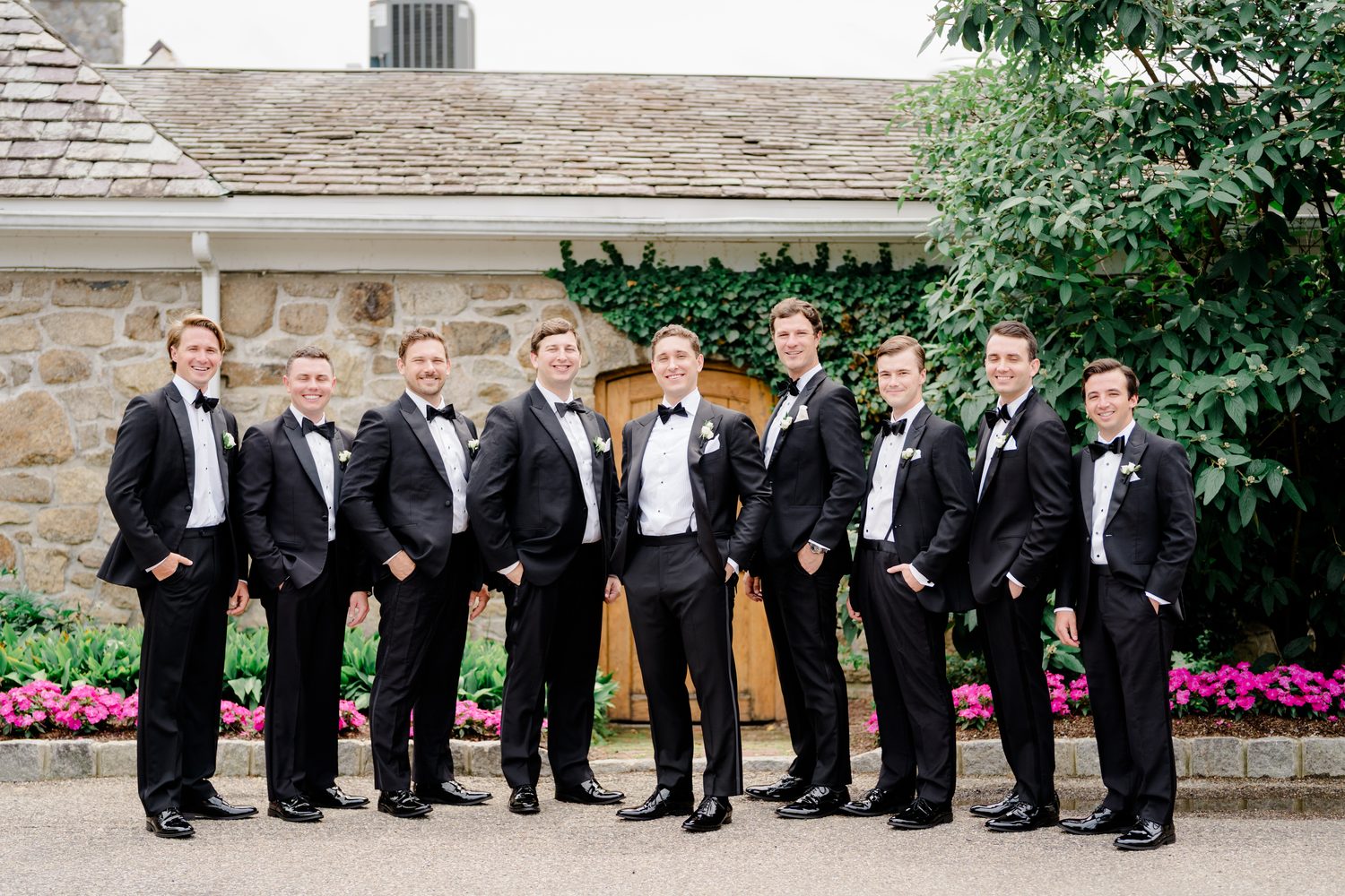The groomsmen's formal group portrait in black tuxedos