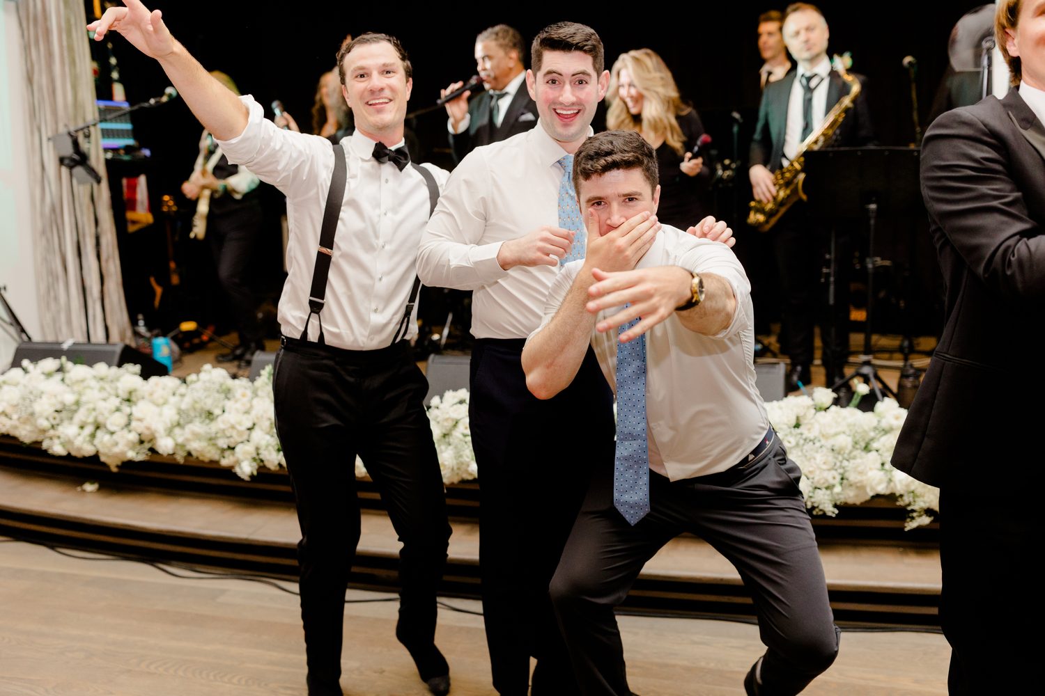 The groomsmen dancing on stage with the live band, NJ wedding photographer Susan Elizabeth Photography